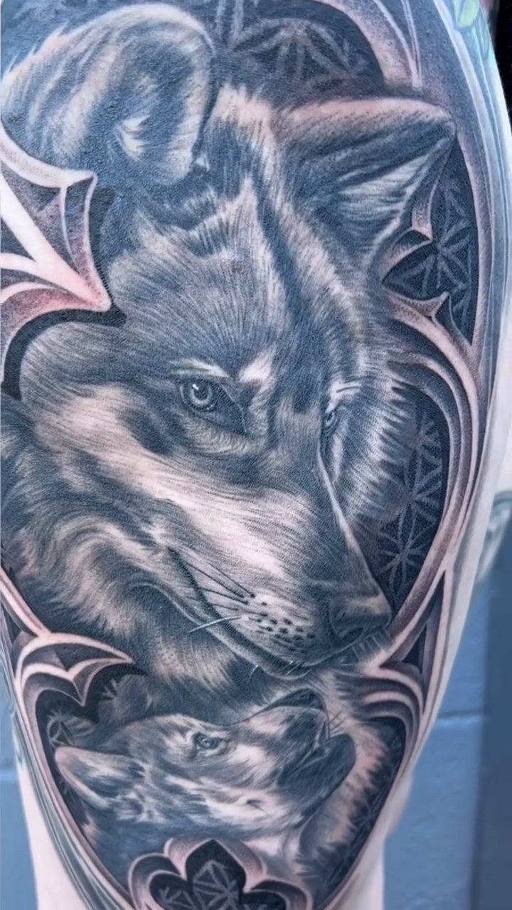 Wolf and cub within gothic frame realism tattoo by Kyle Lopez, Union City, California
