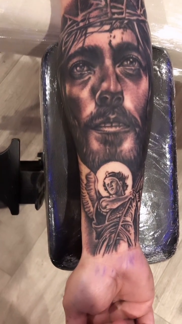 Jesus Christ with an angel realism tattoo by Danny Rodriguez