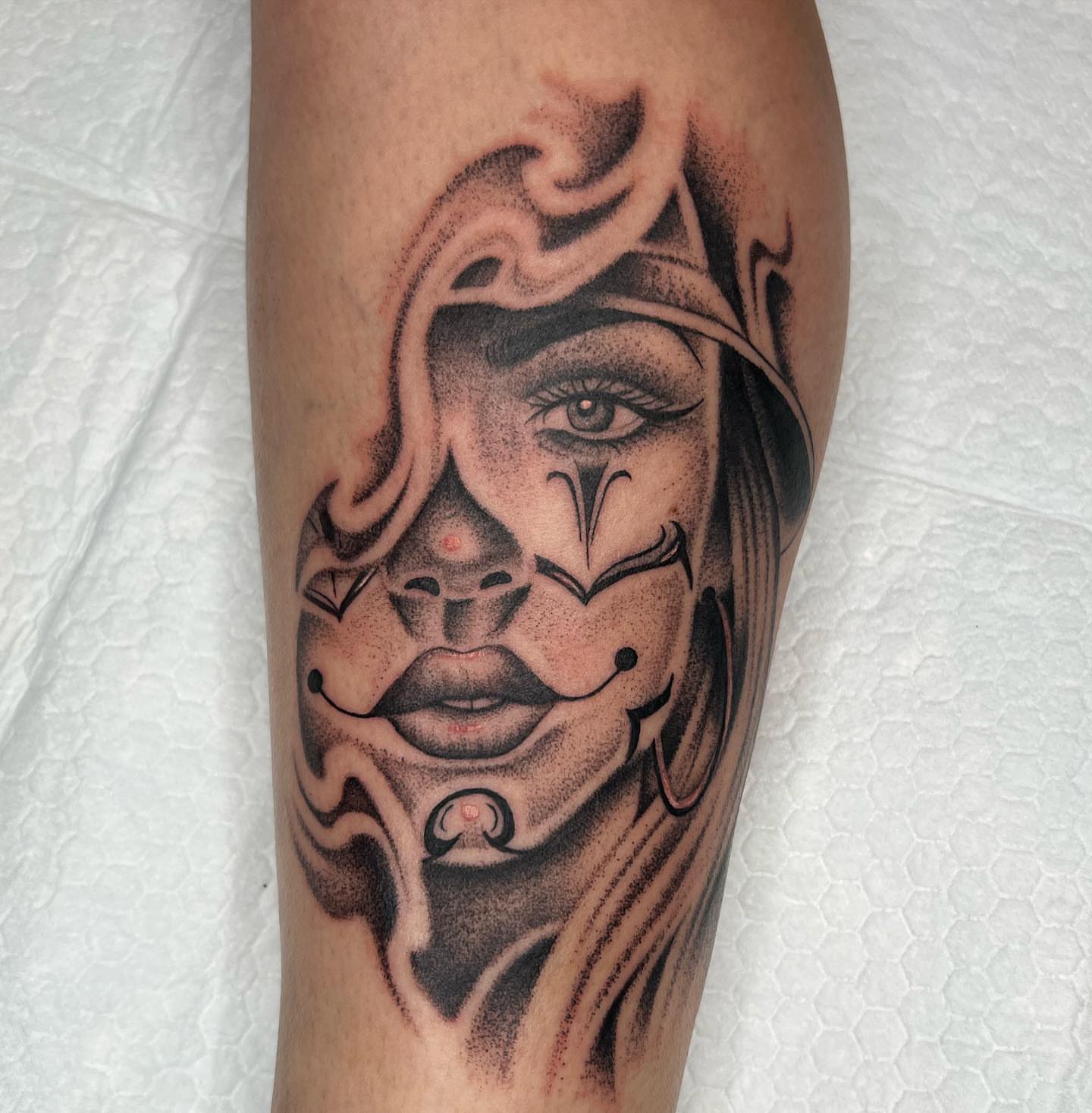 Mask dotwork tattoo on the forearm by Kayla Cordova