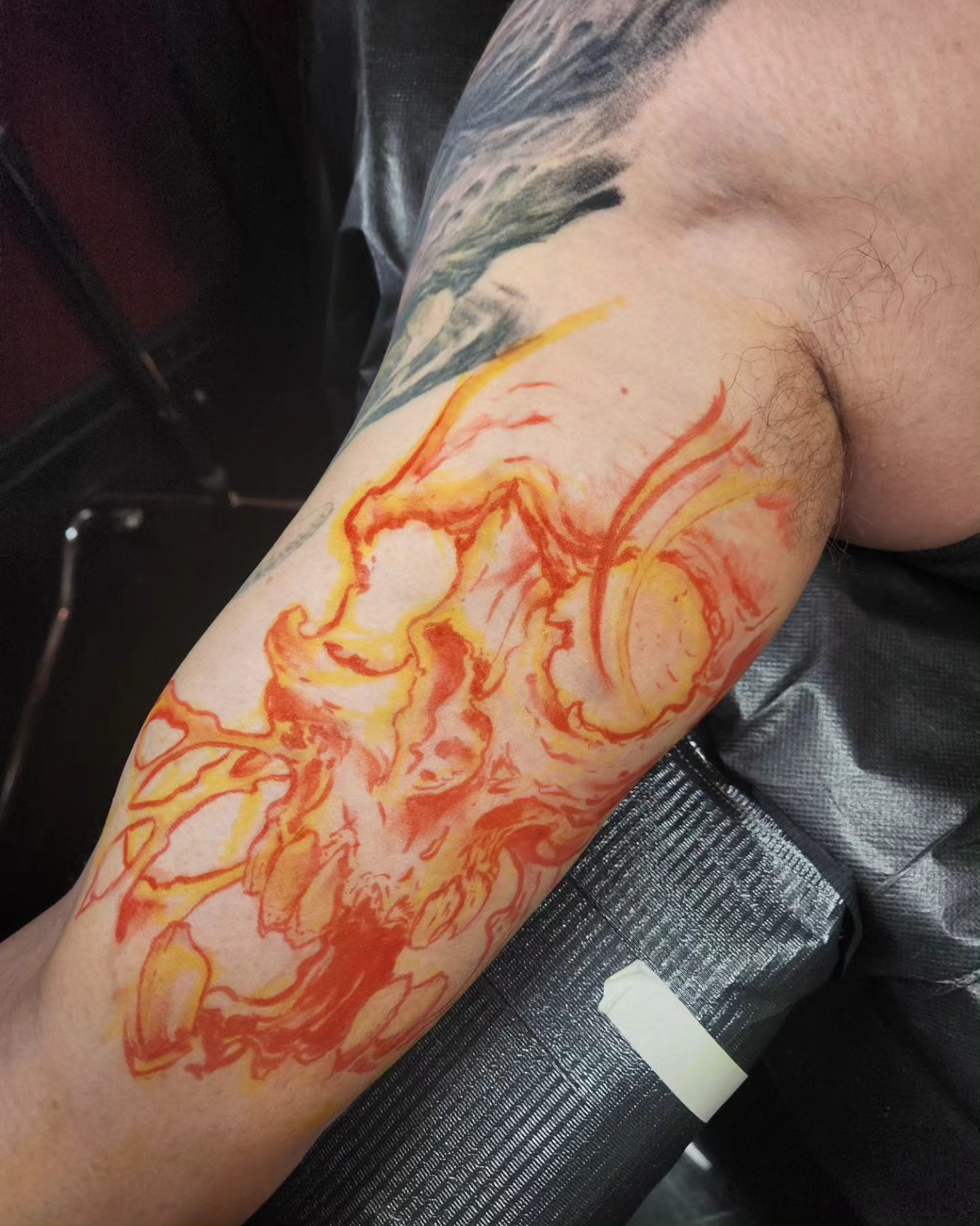 Flame watercolor tattoo on the forearm by Jake Goss, Salt Lake City, Utah