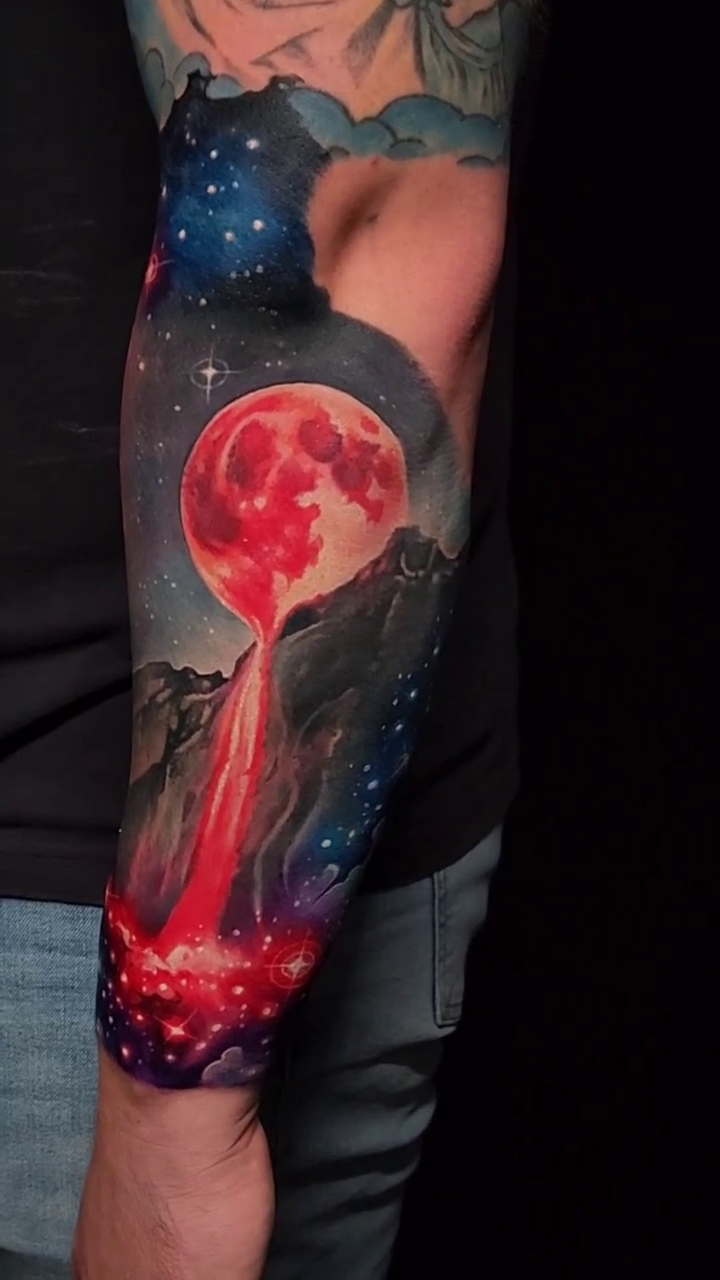 Cosmic landscape with red moon realism tattoo by Tyler Malek