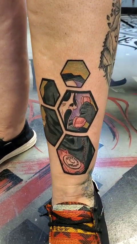 Woman on phone in hexagons neo-traditional tattoo by Chris TL Jones