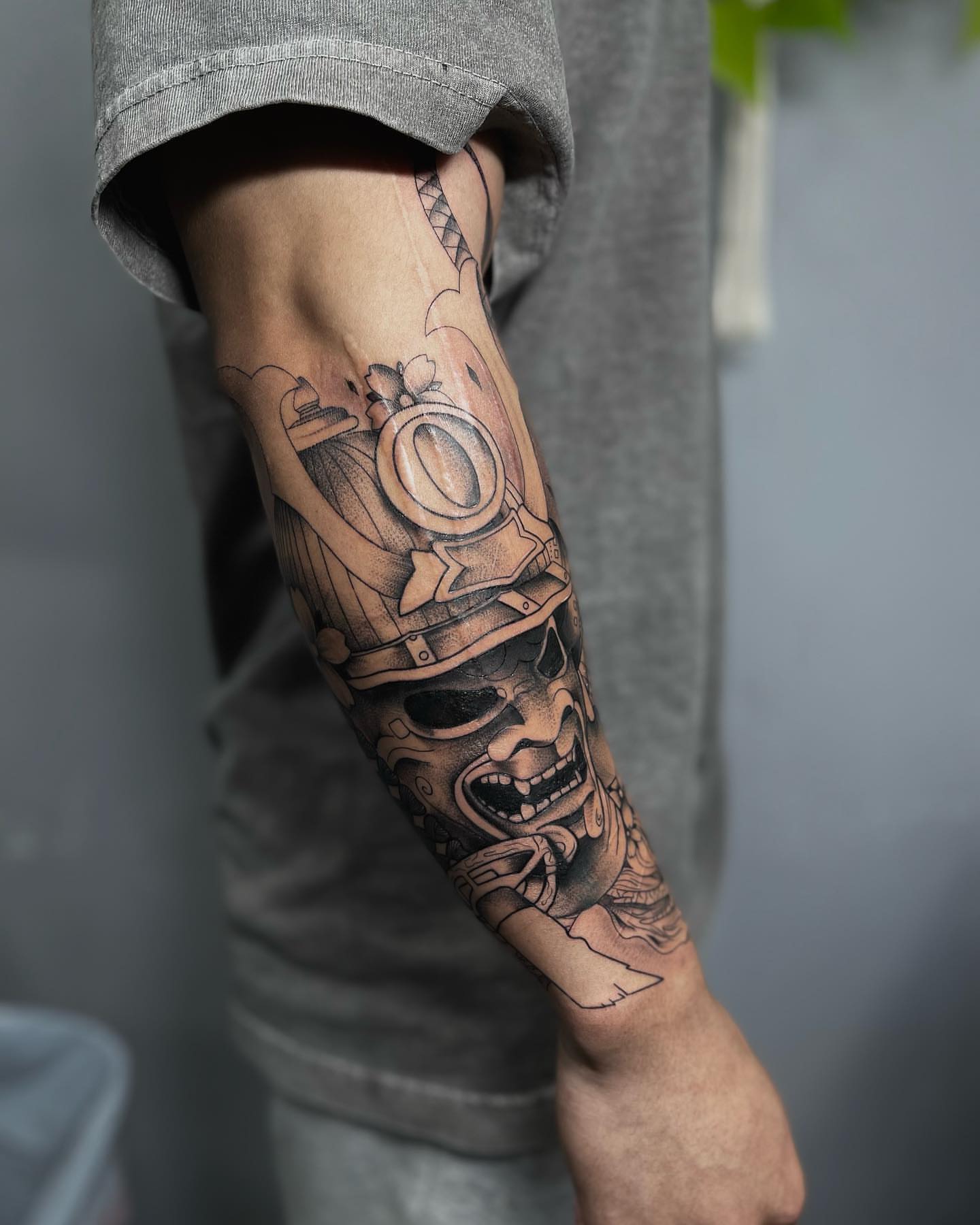 Skull with helmet realism tattoo on the forearm by Beans