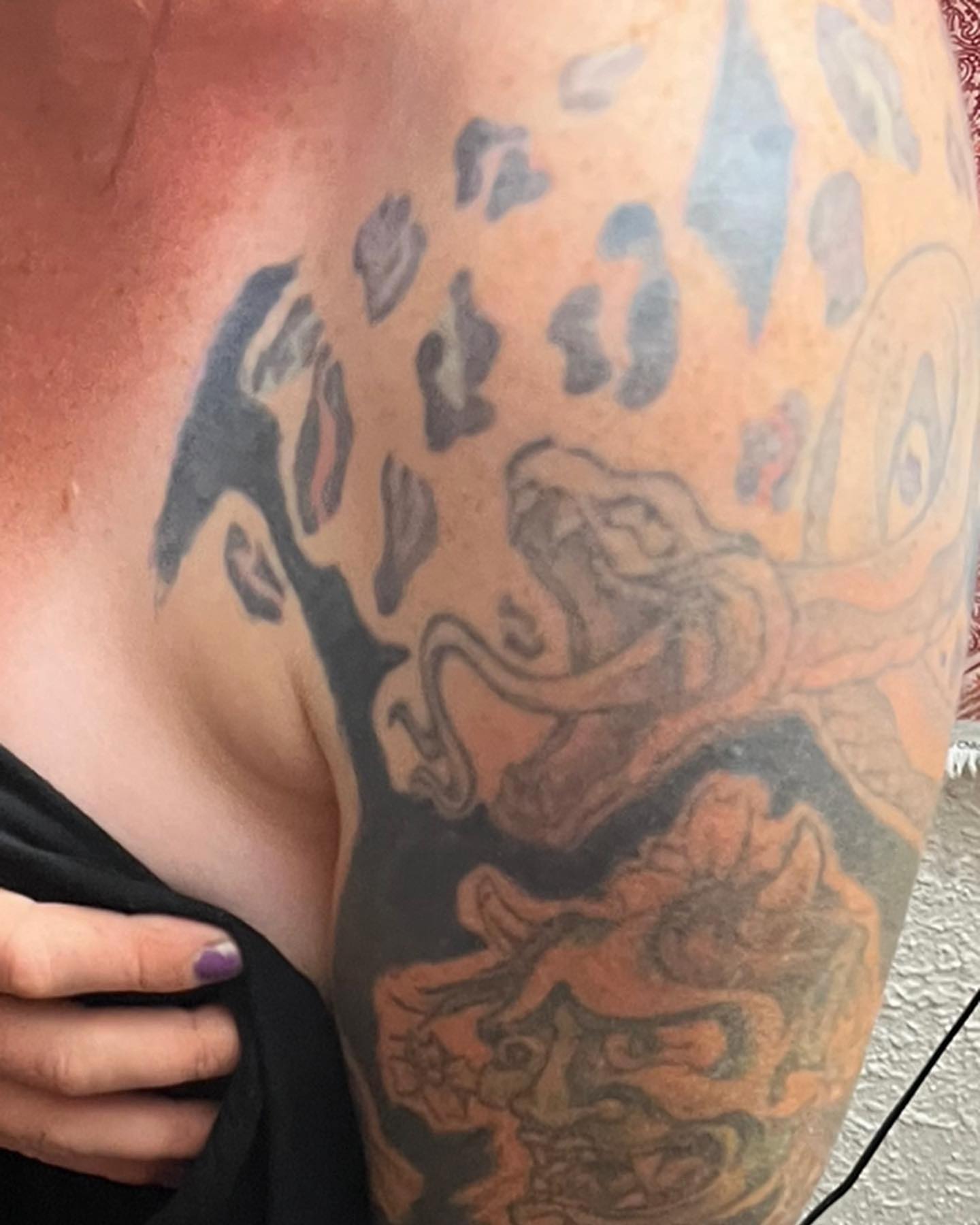 Lion and floral American traditional tattoo on the chest by Brittney