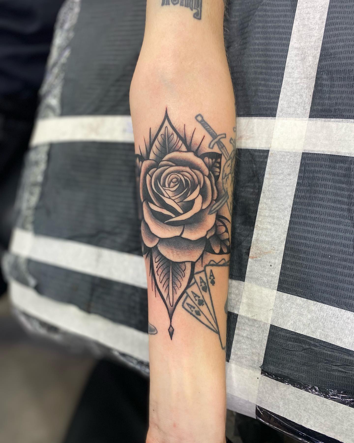 Rose and dagger realism tattoo on the forearm by Brian Keith