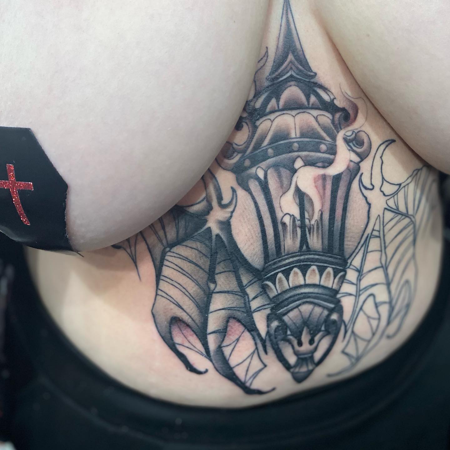 Tower with flames black and grey tattoo on the torso by Brian Keith