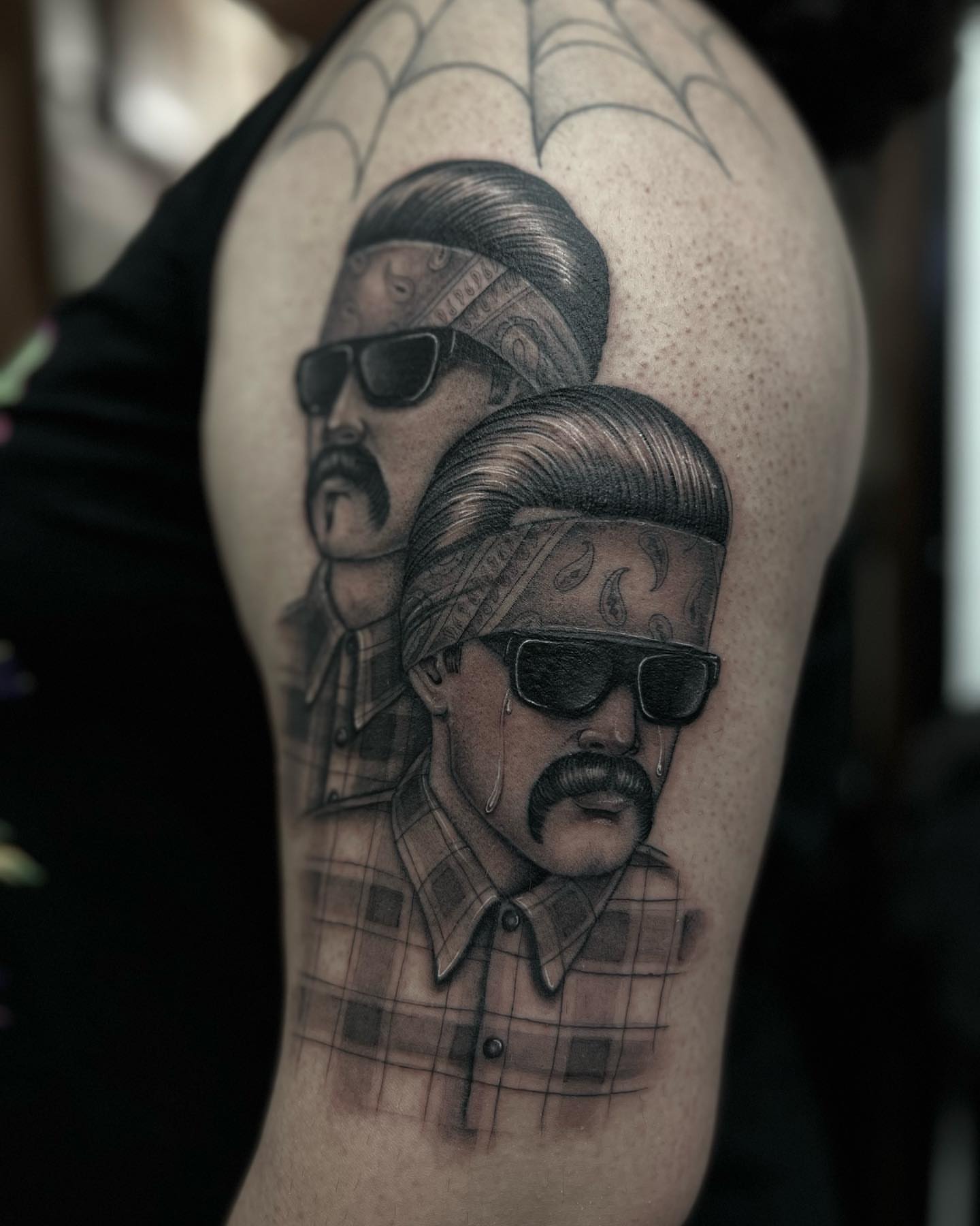Two men with bandanas realism tattoo on the shoulder by Valerie Dominguez