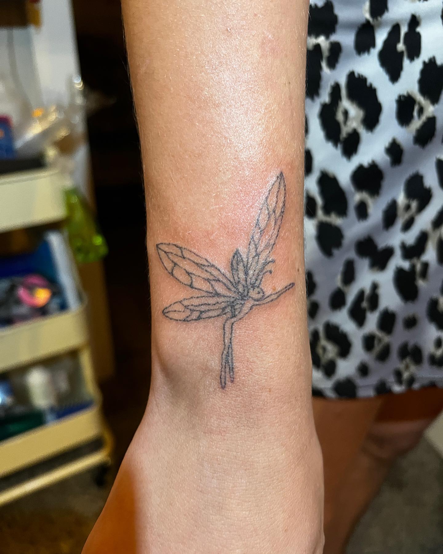 Dragonfly black and grey tattoo on the forearm by mars