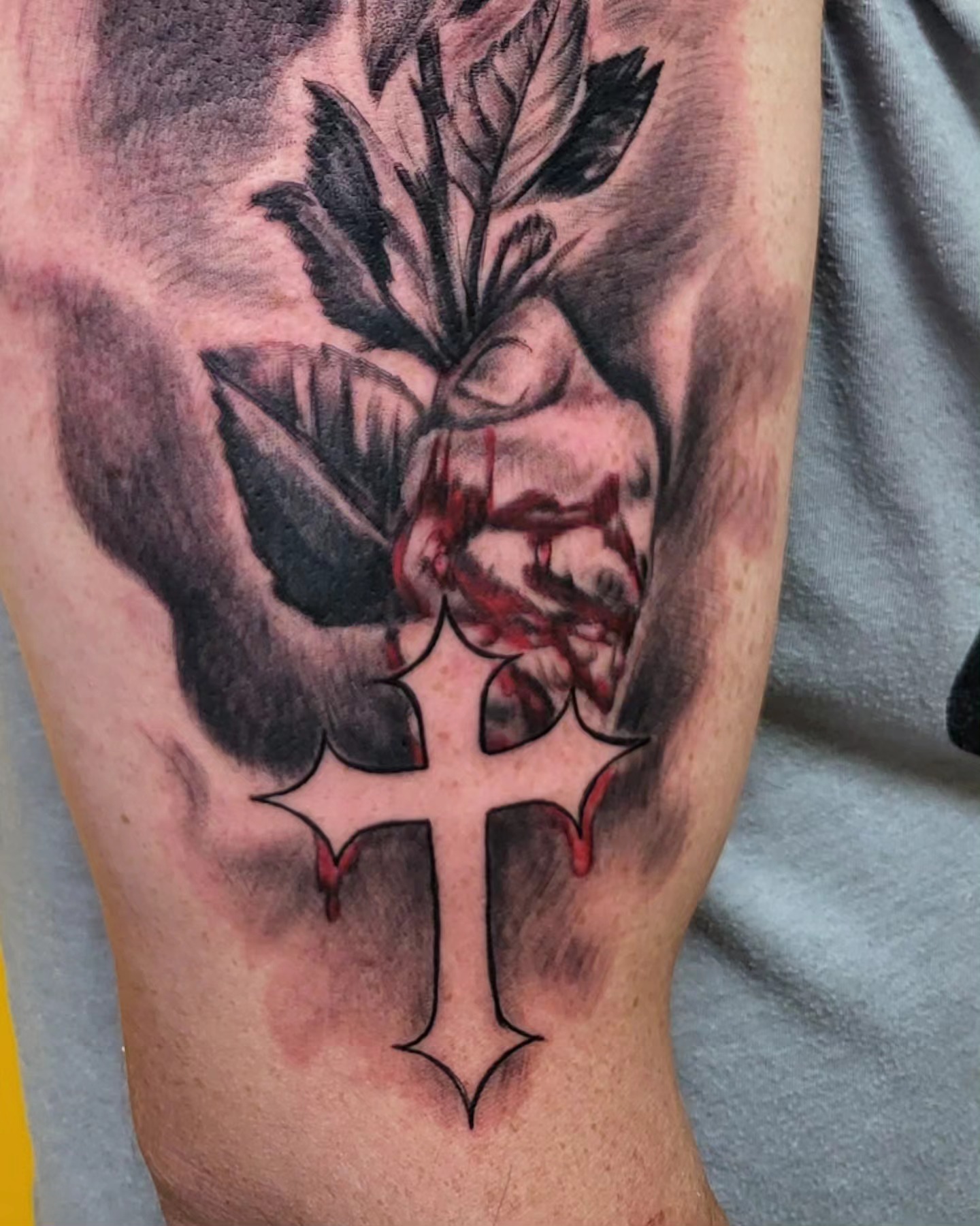 Cross with bleeding rose realism tattoo on the forearm by Mike Stamper