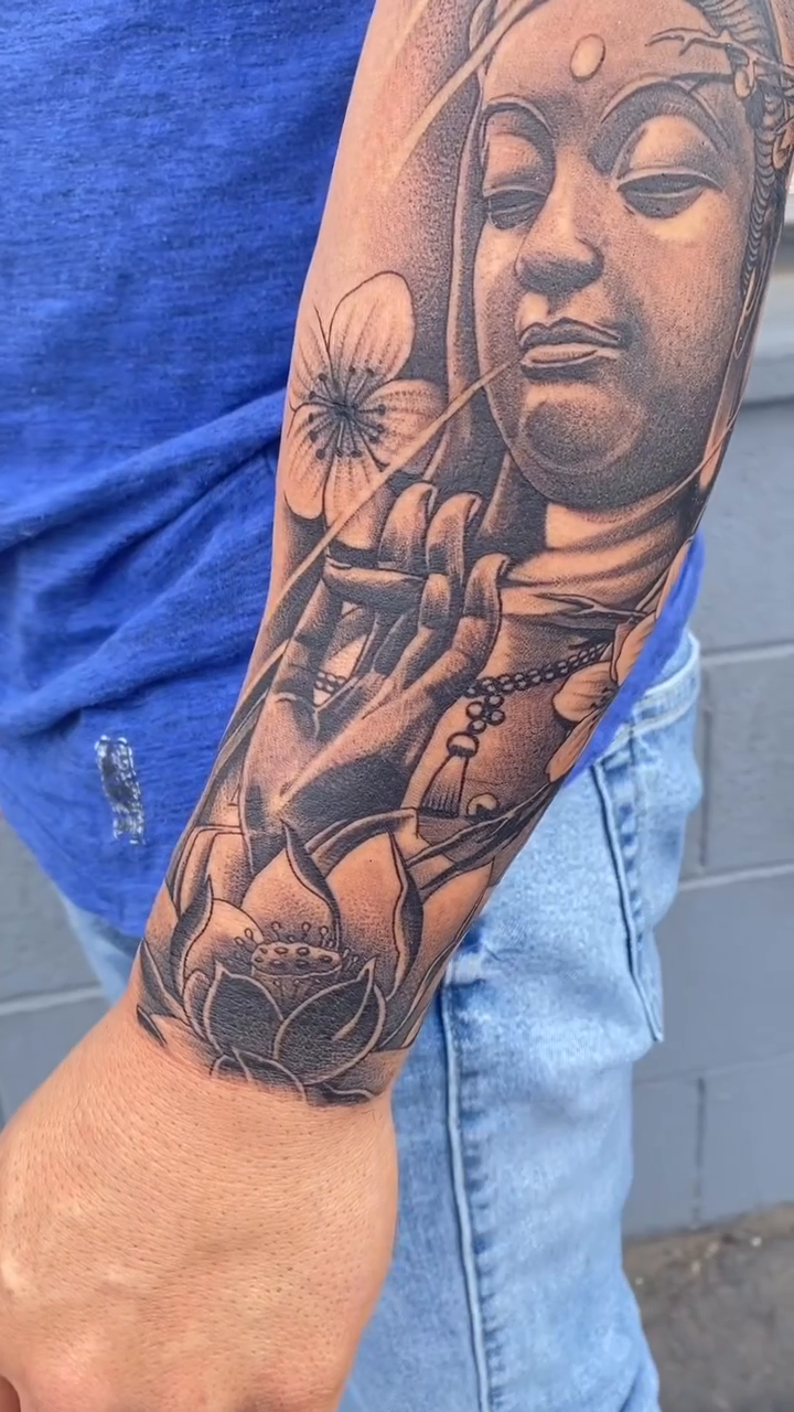 Buddha and lotus flowers realism tattoo by Kyle Lopez, Union City, California