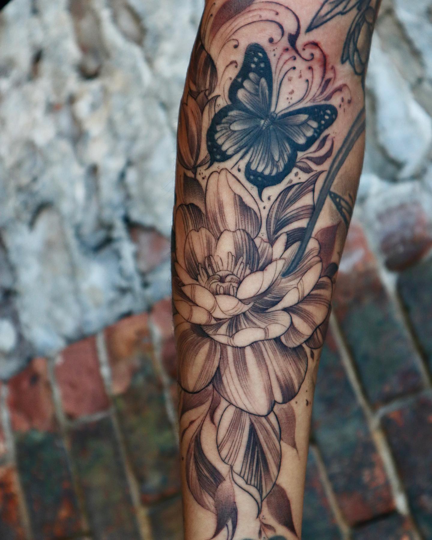 Butterfly and lotus realism tattoo on the forearm by elvis flores
