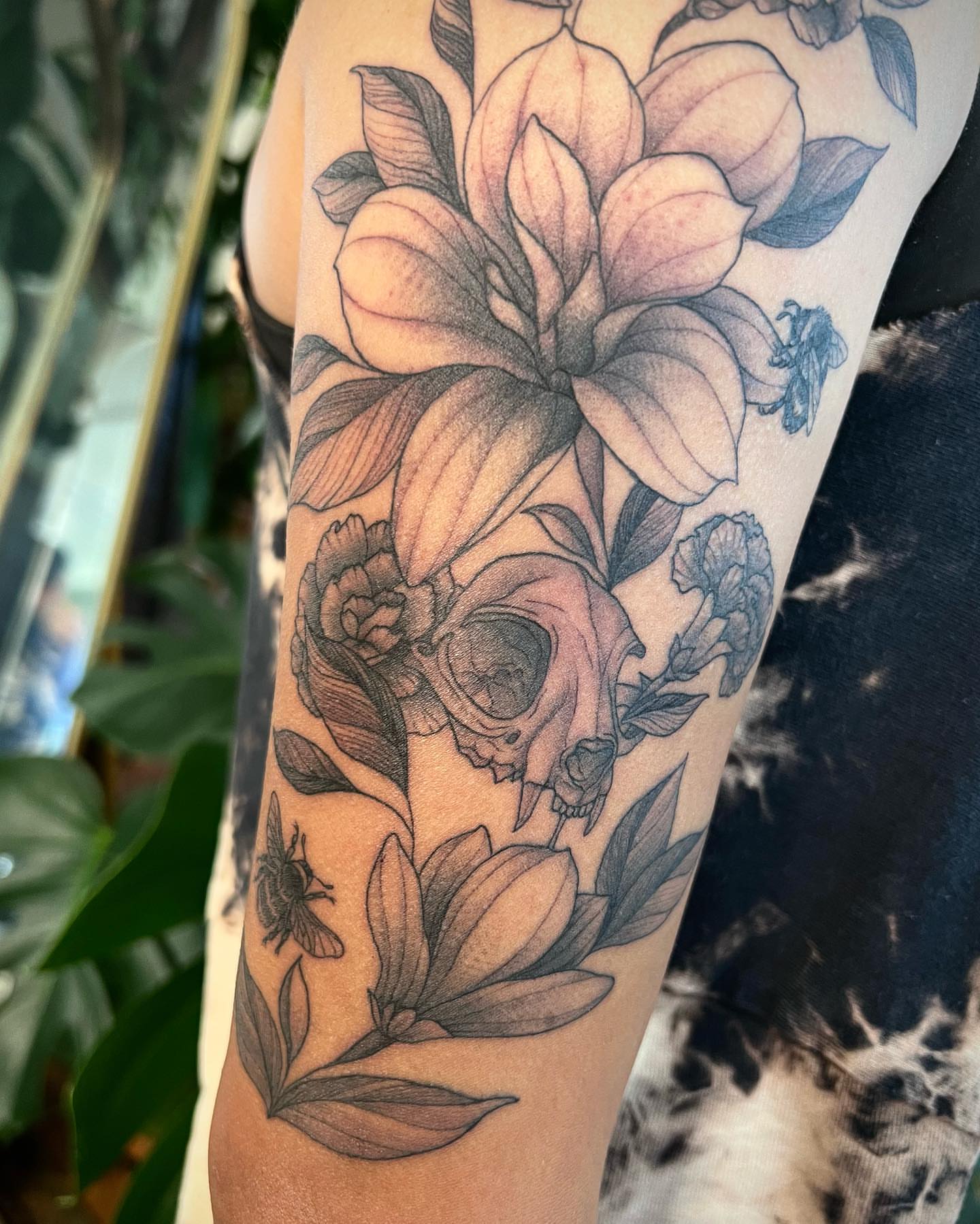 Flower skull bee realism tattoo on the forearm by Mia Manzanedo