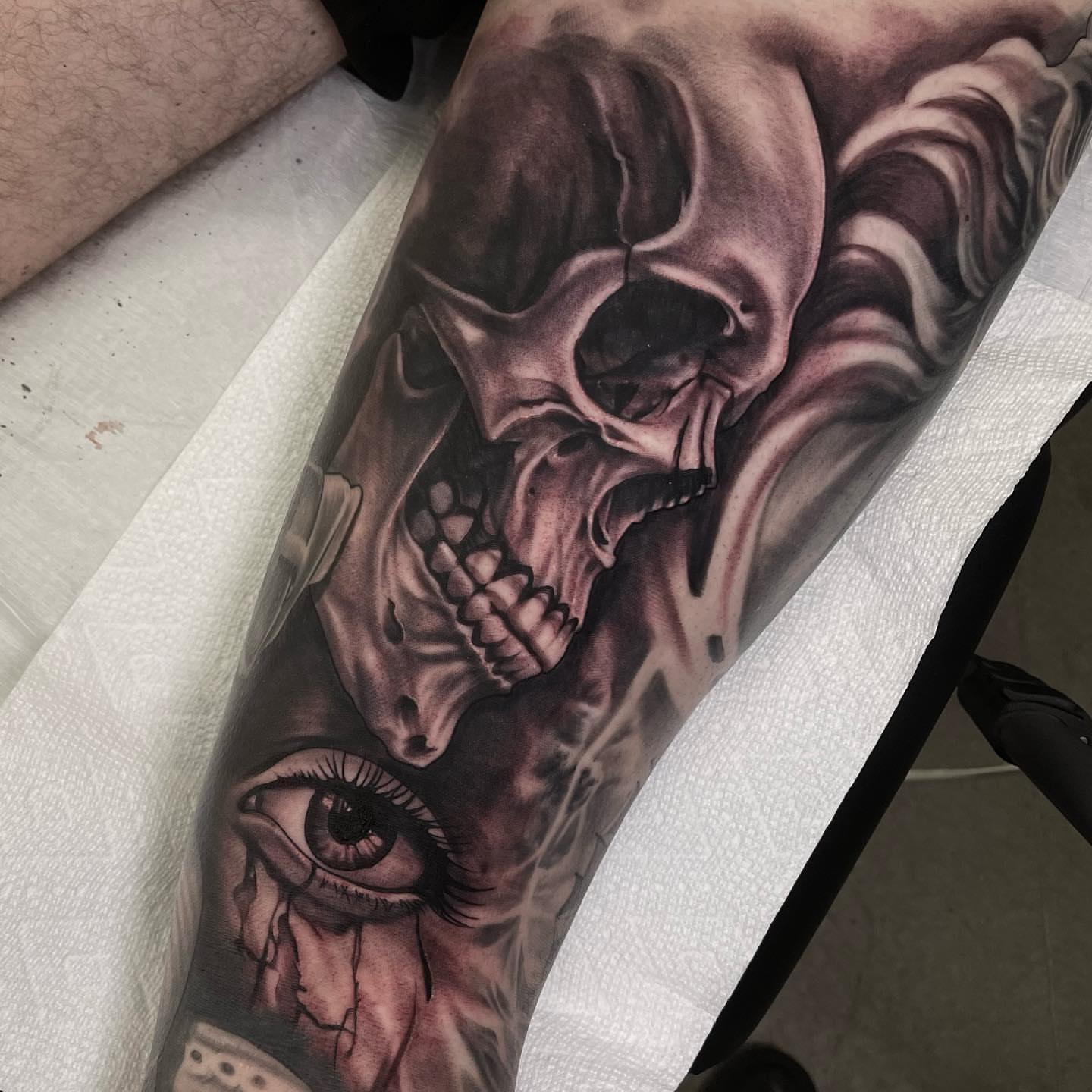 Skull and eye realism tattoo on the forearm by Jake Fujimura