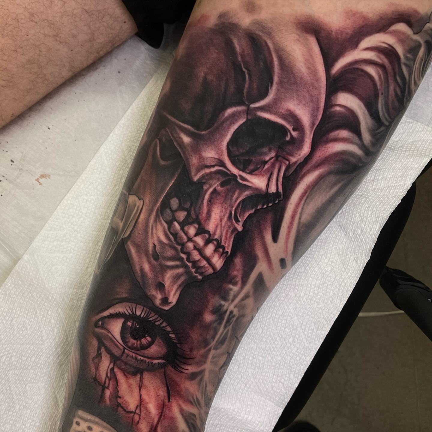 Skull and eye realism tattoo on the forearm by Jake Fujimura