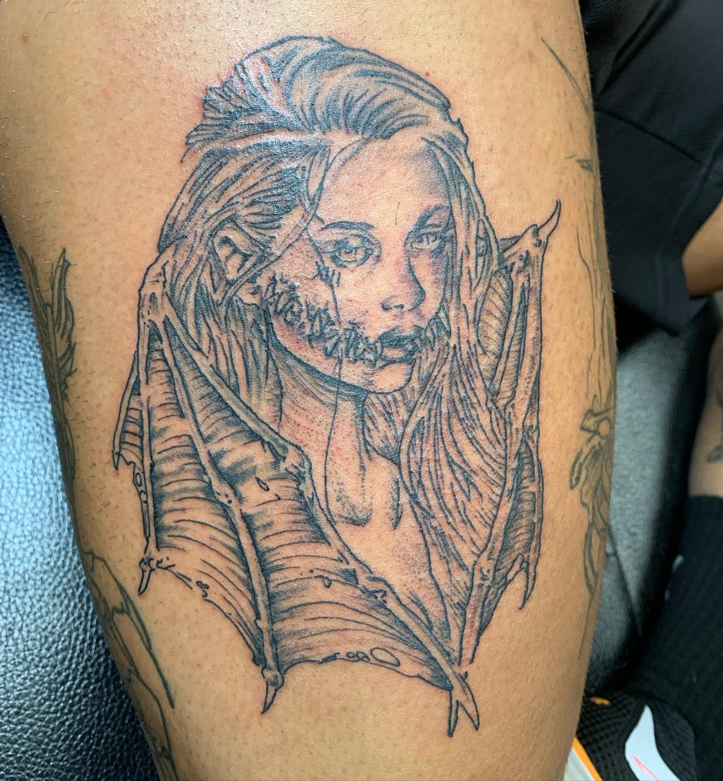 Woman with feathers realism tattoo on the thigh by @goat76