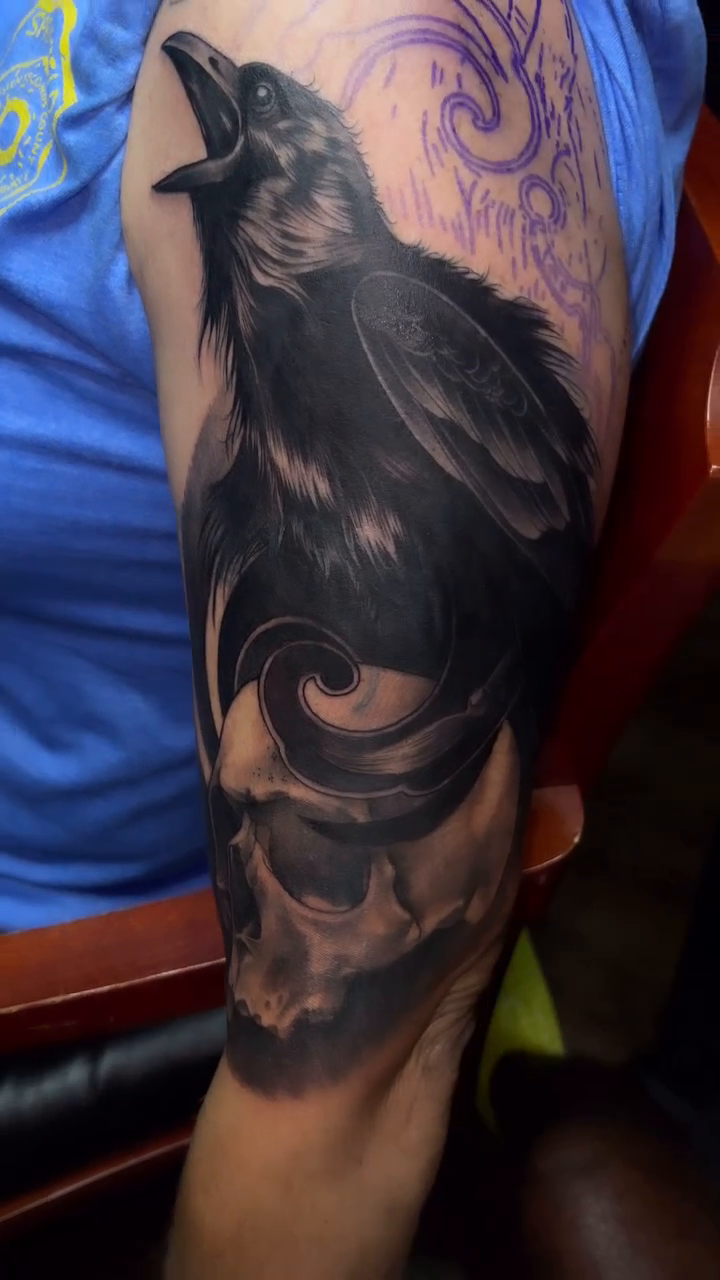 Raven and skull realism tattoo by Anwon Johnson