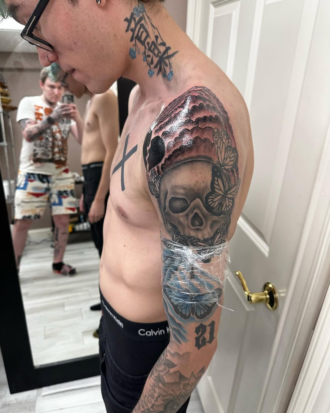 Skull with headdress and butterflies realism tattoo on the upper arm by Silky Inks NJ 201, North Haledon, New Jersey