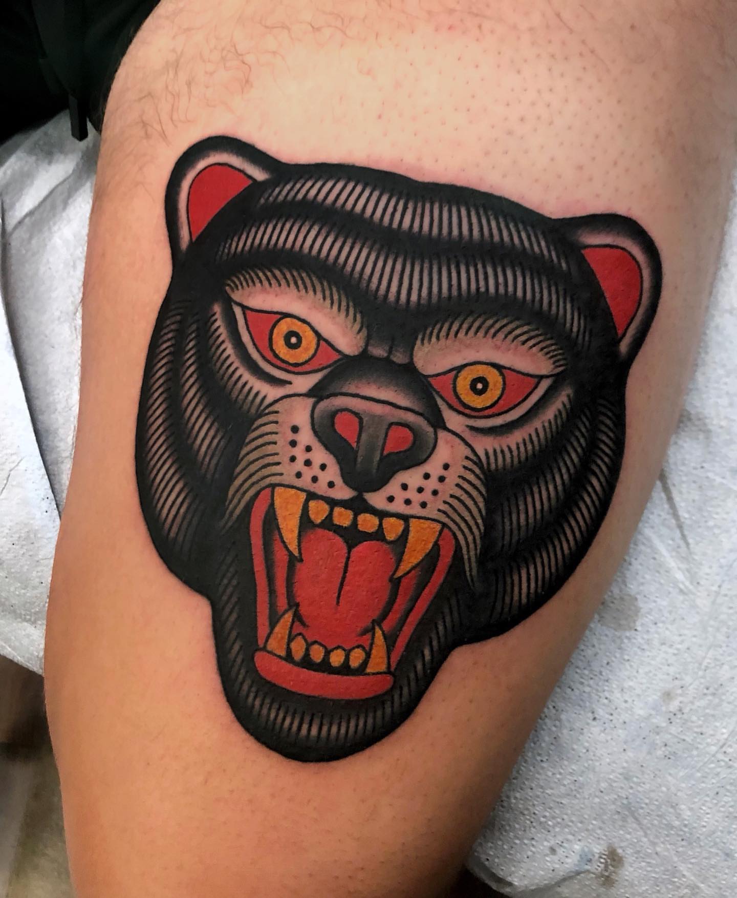 Bear head American traditional tattoo on the thigh by Ben Fiedler