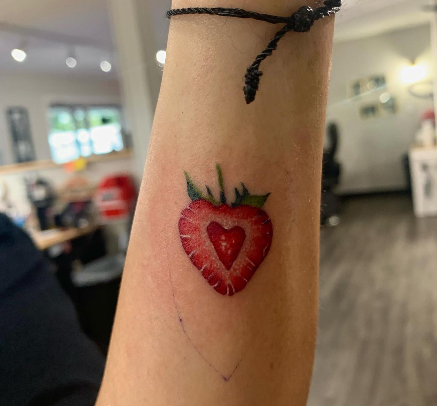 Strawberry realism tattoo on the forearm by Storm
