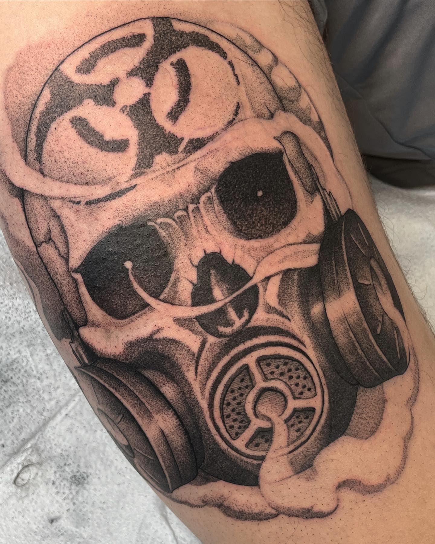 Gas mask realism tattoo on the thigh by Will Campbell