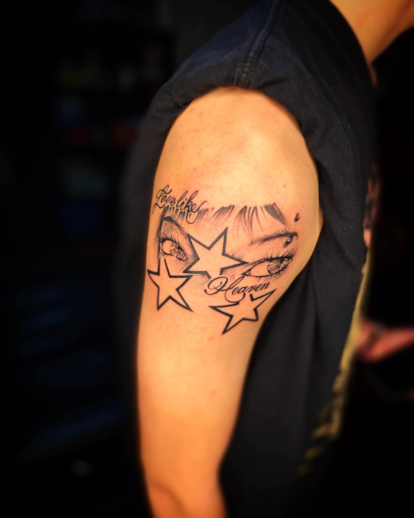 Eyes and stars realism tattoo on the shoulder by @inkhazmat