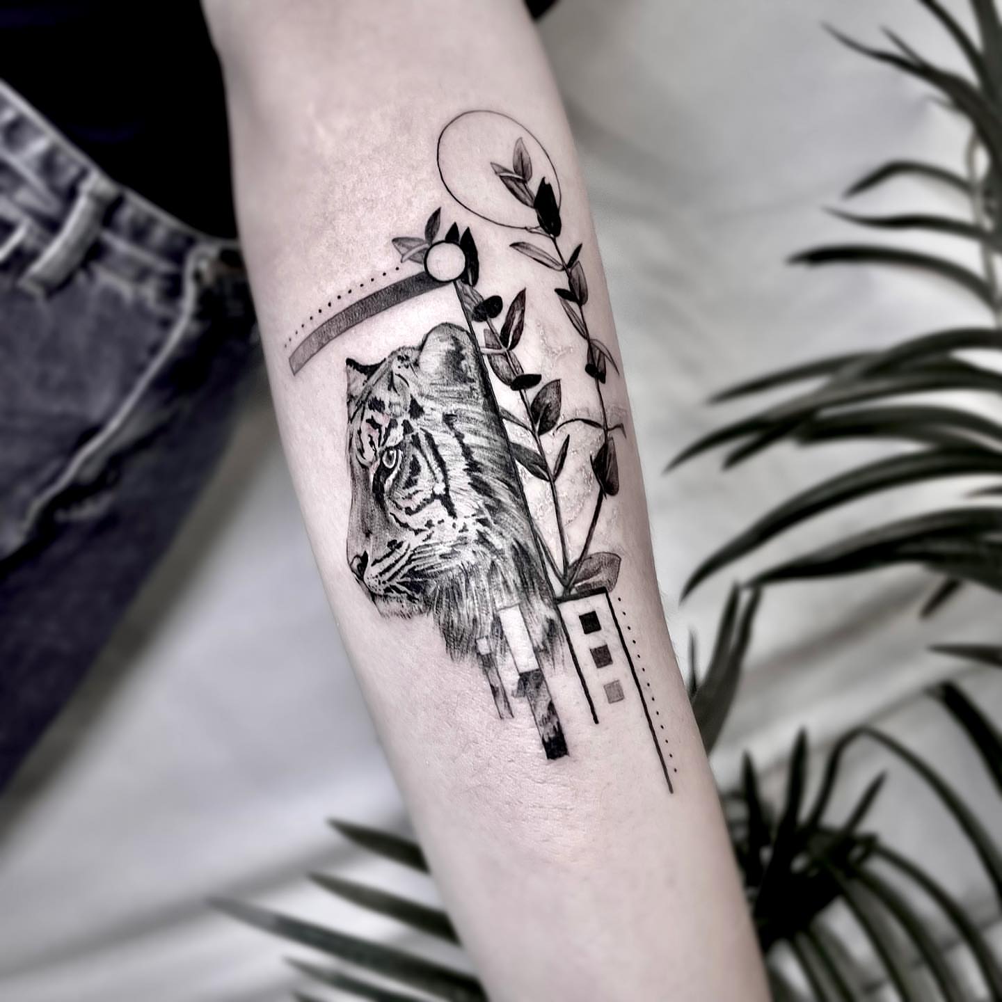 Tiger and cityscape realism tattoo on the forearm by Seraph Geometry
