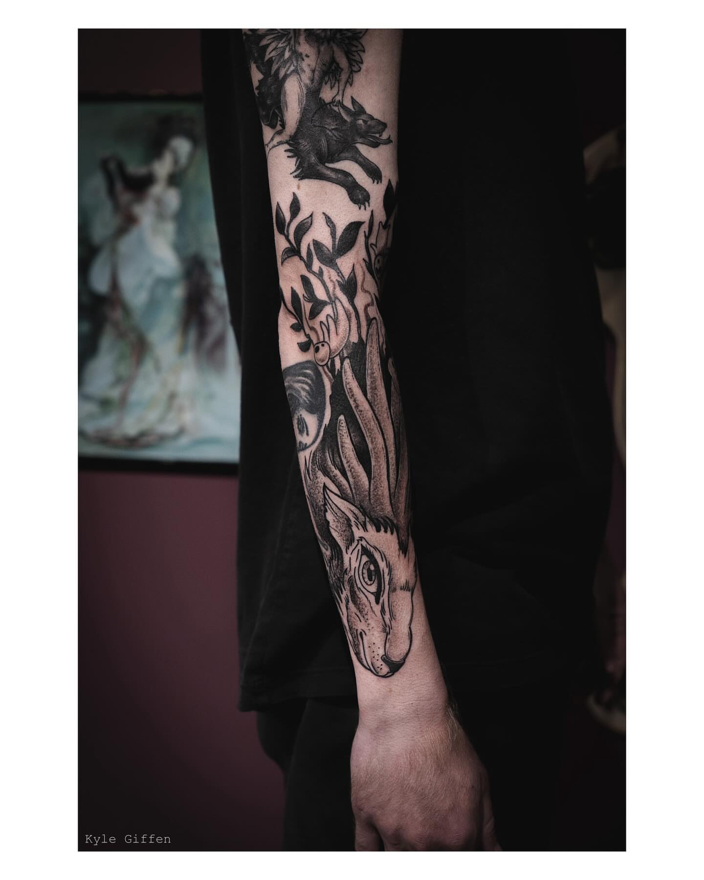 Wolf and foliage realism tattoo on the forearm by Kyle Giffen - Tattoo Artist