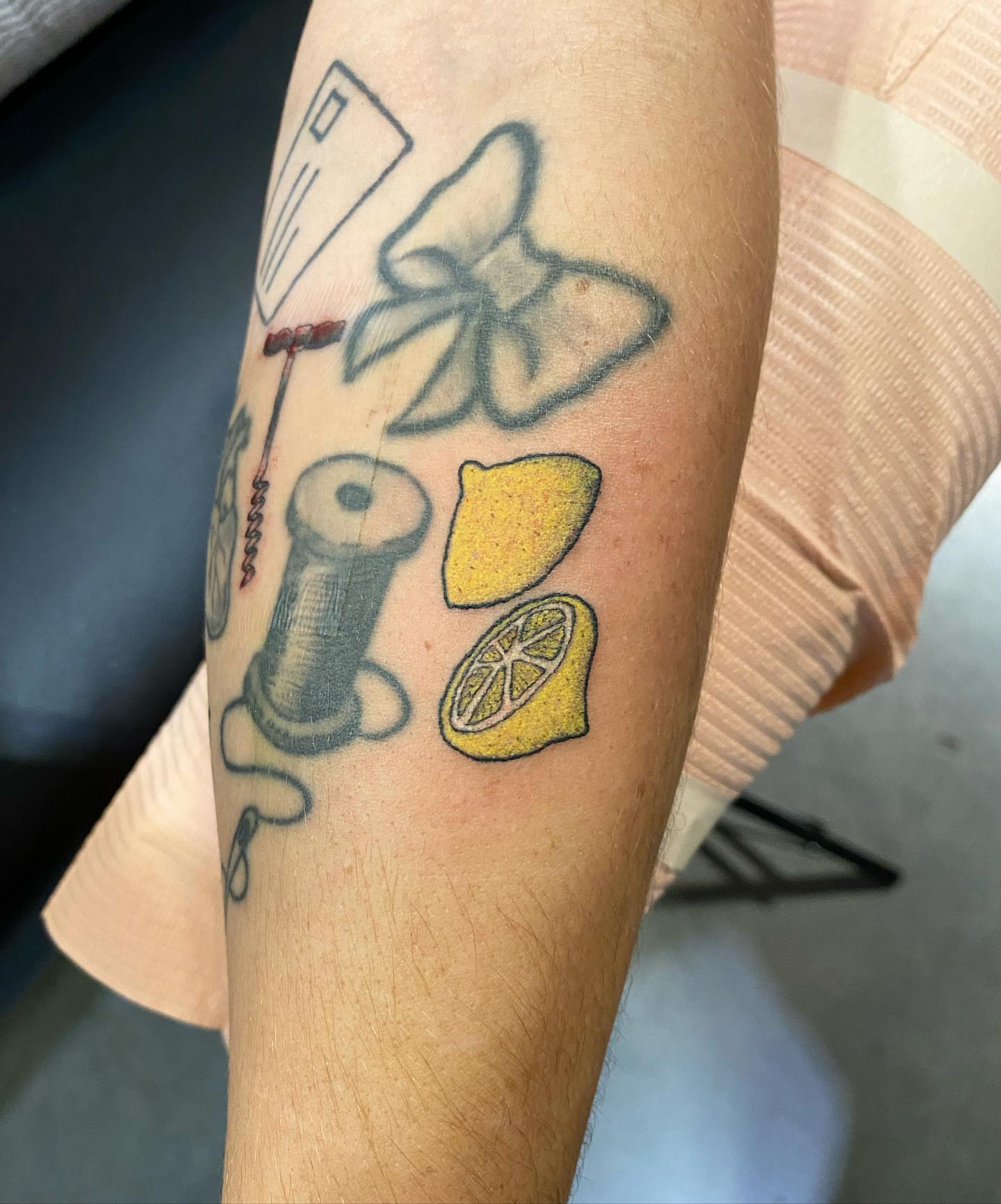 Lemons and sewing tools neo-traditional tattoo on the forearm by Maddy ⁂, Murfreesboro, Tennessee