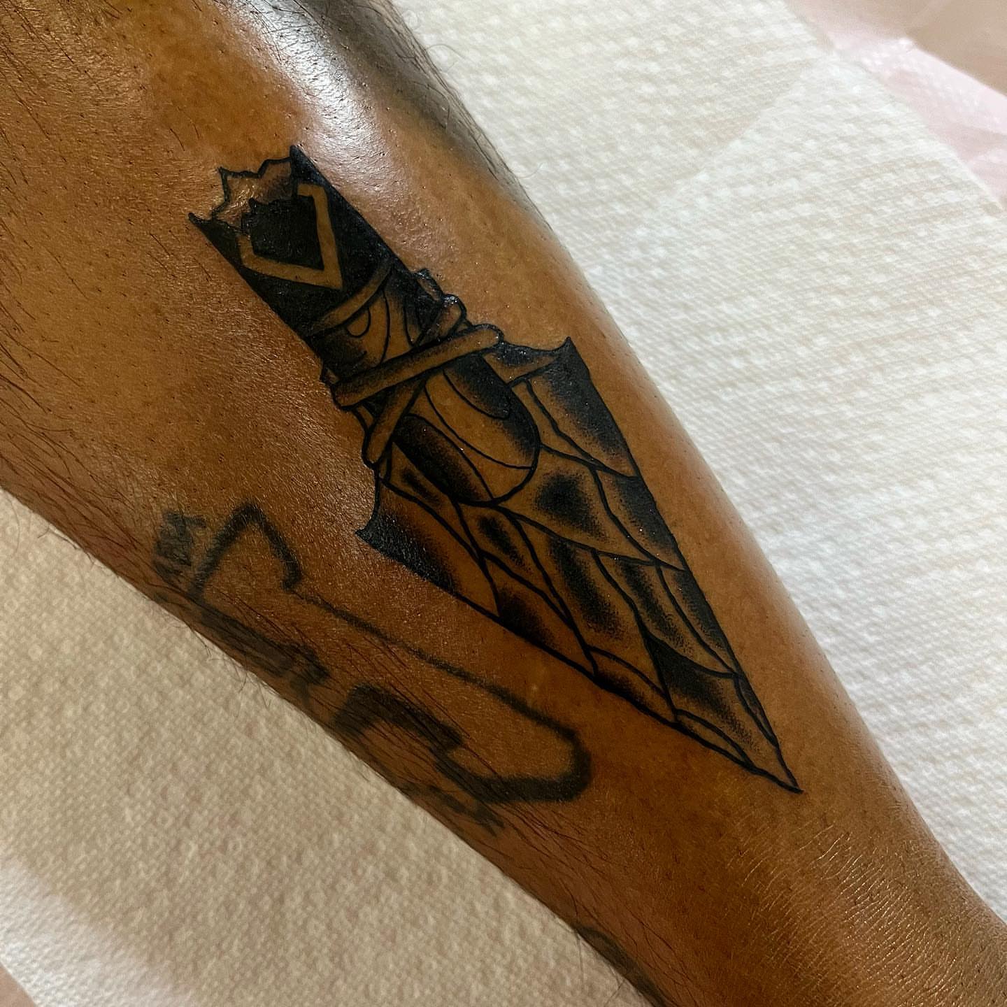 Knife black and grey tattoo on the forearm by Pedroux M.