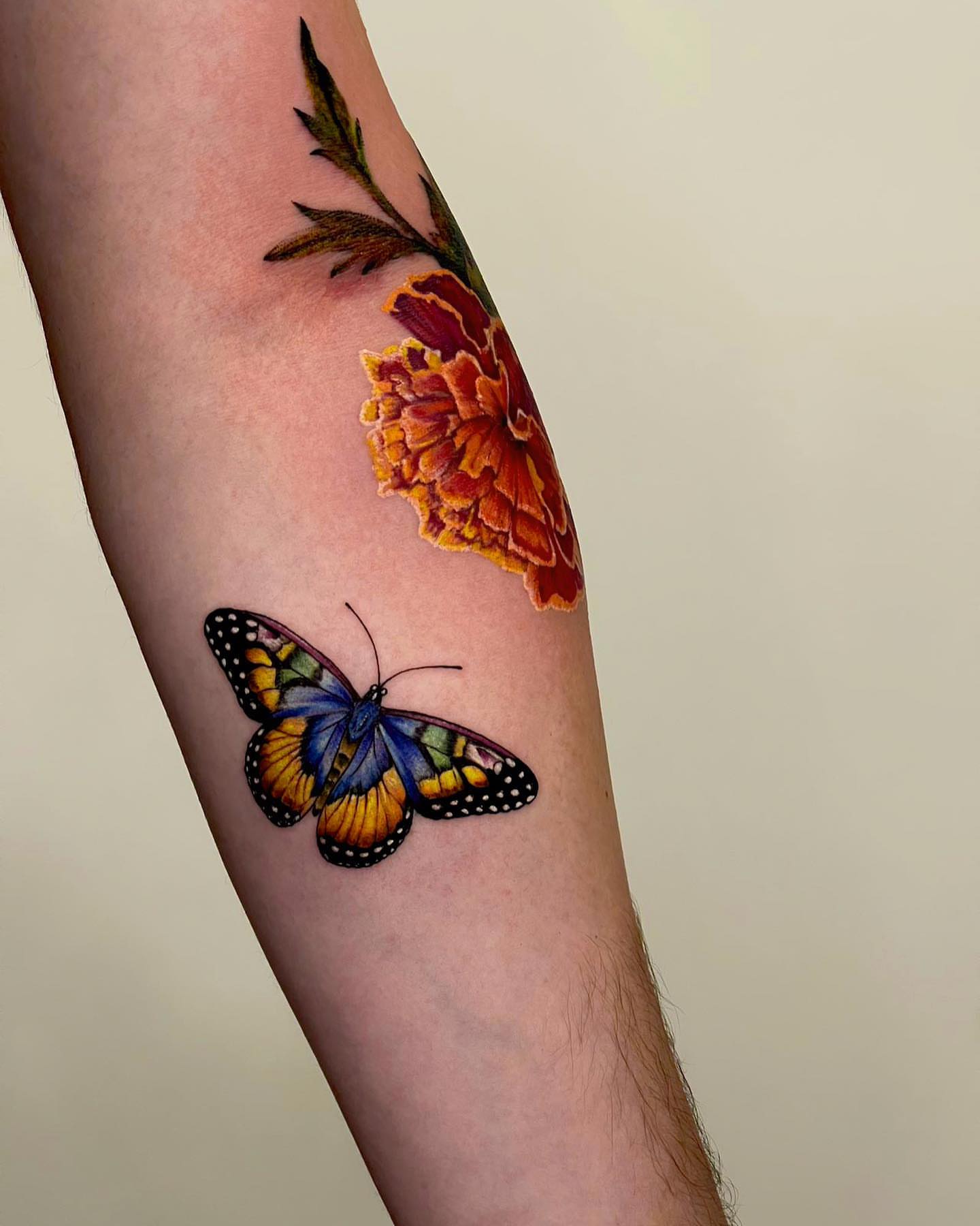 Butterfly and flower realism tattoo on the forearm by Seattle Tattoo Artist PingPing, Seattle, Washington
