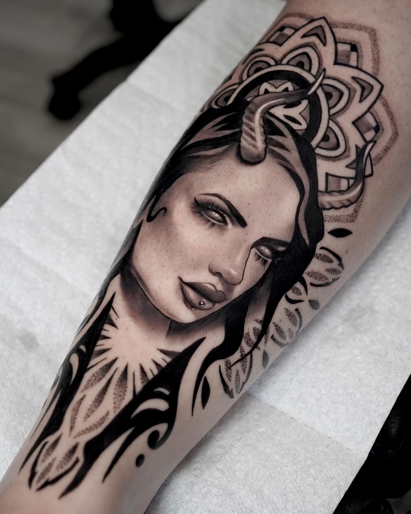 Woman's face realism tattoo on the forearm by Jess Dominguez