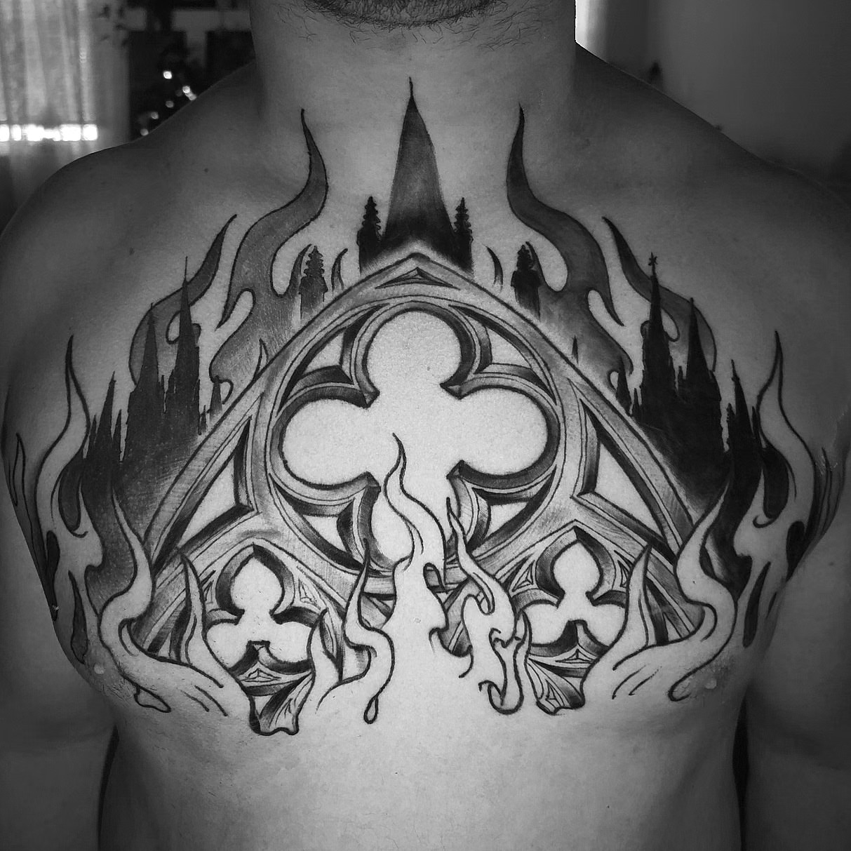 Gothic cross geometric tattoo on the chest by Christian Mulvey