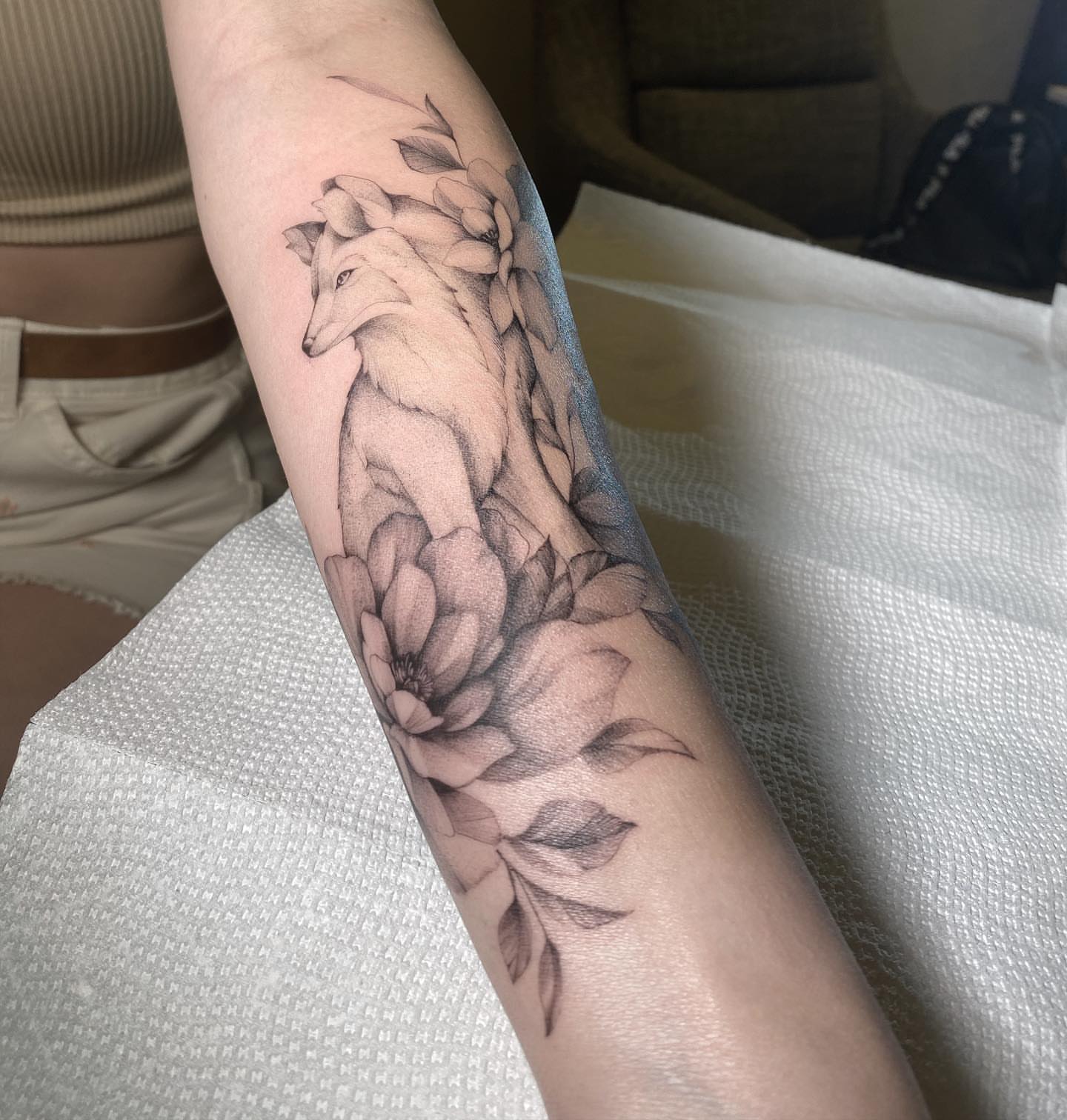 Fox and flowers realism tattoo on the forearm by Ninna
