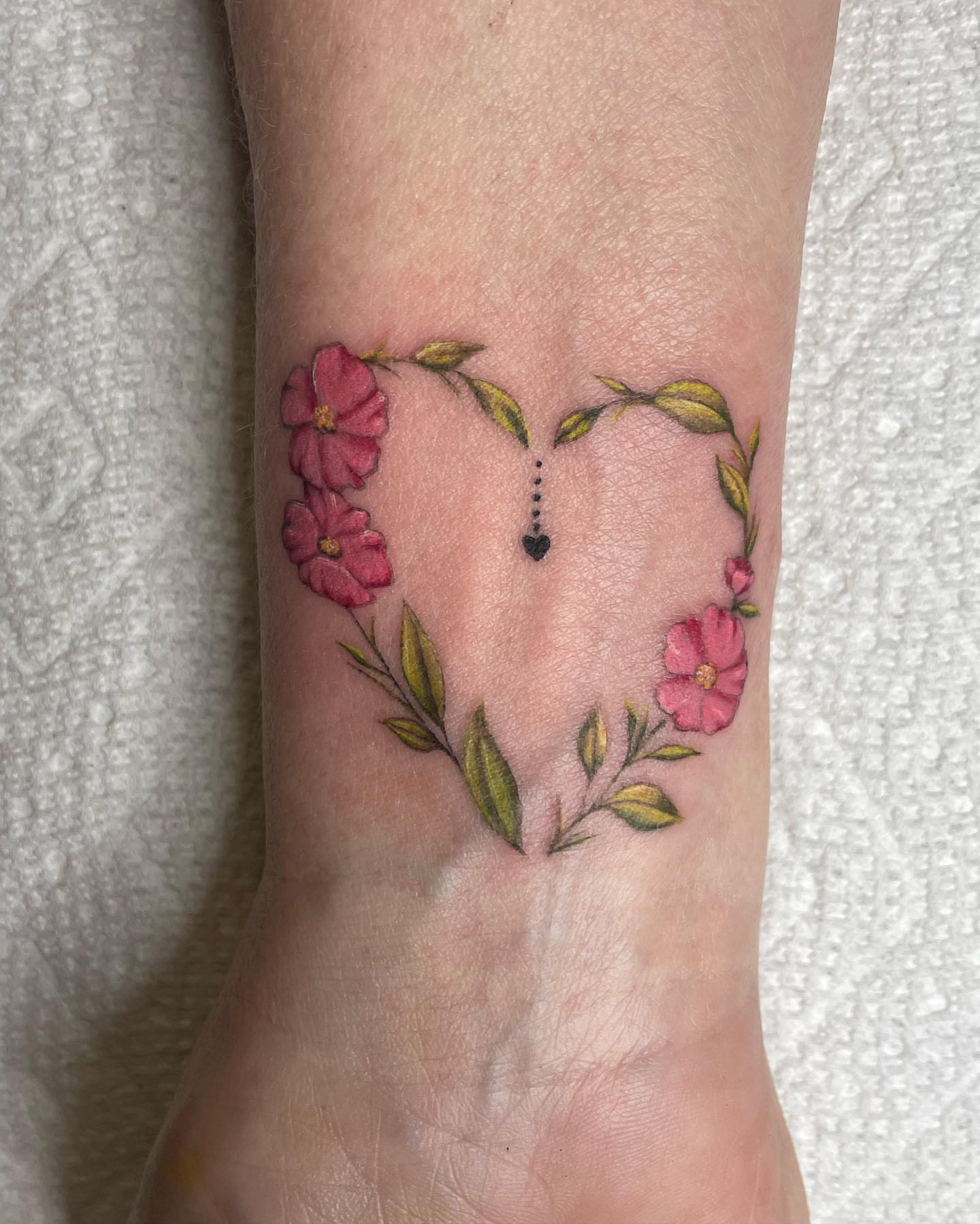 Flower heart dotwork tattoo on the foot by Michelle