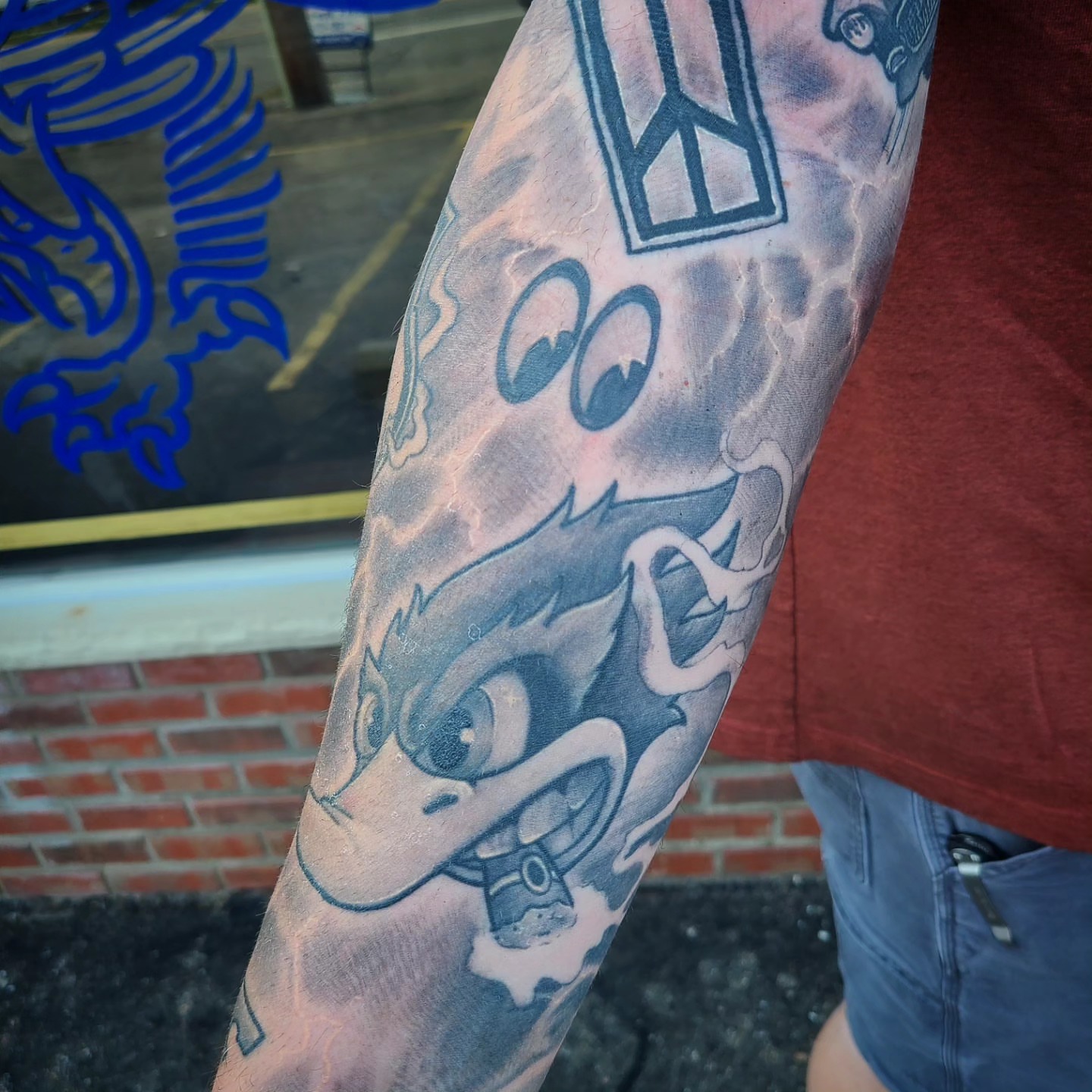 Angry bird black and grey tattoo on the forearm by David Johnson
