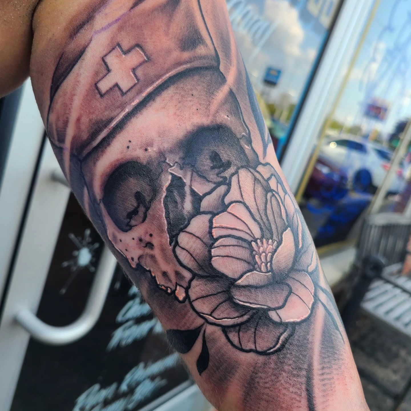 Skull and flower realism tattoo on the forearm by David Johnson