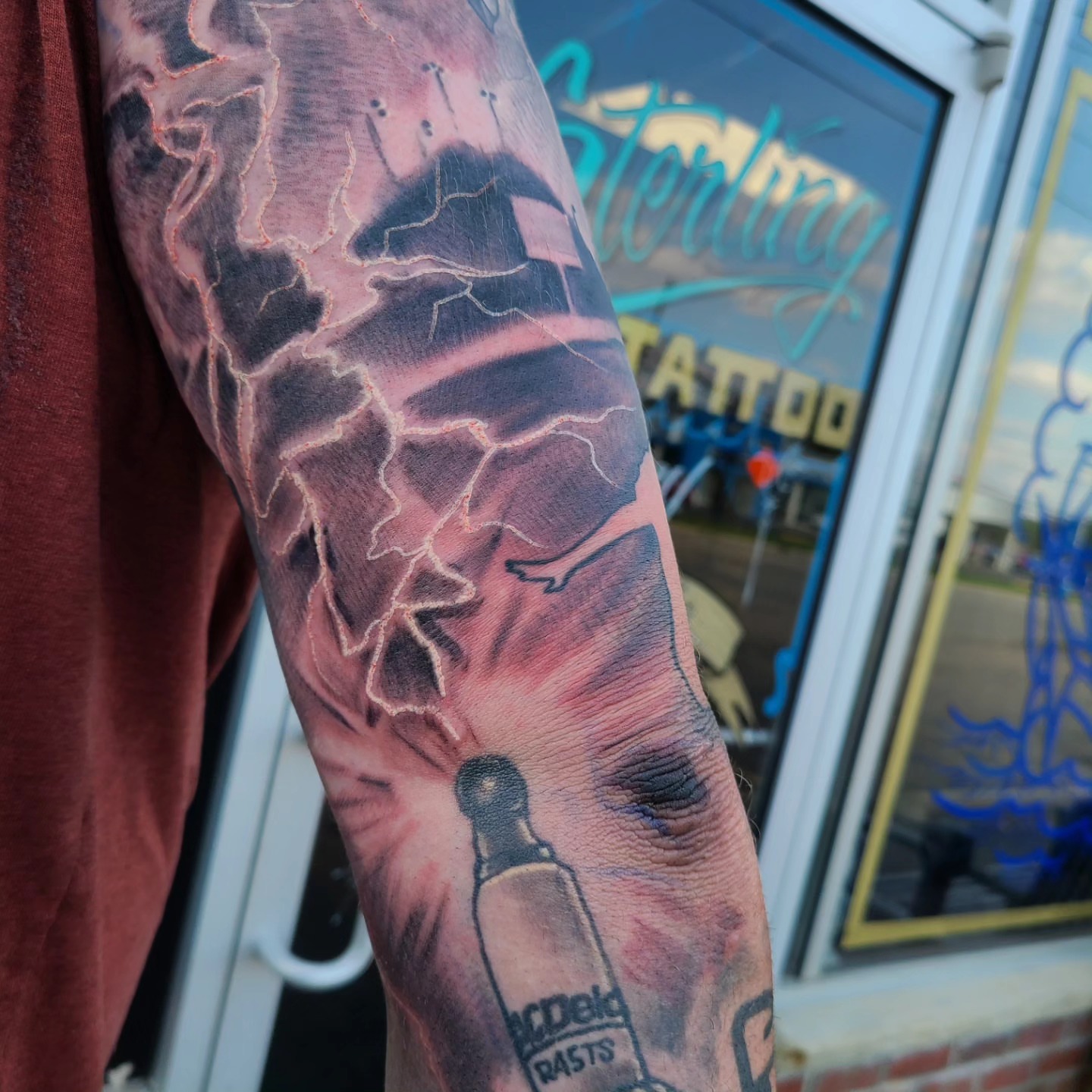 Lightning bolt realism tattoo on the forearm by David Johnson