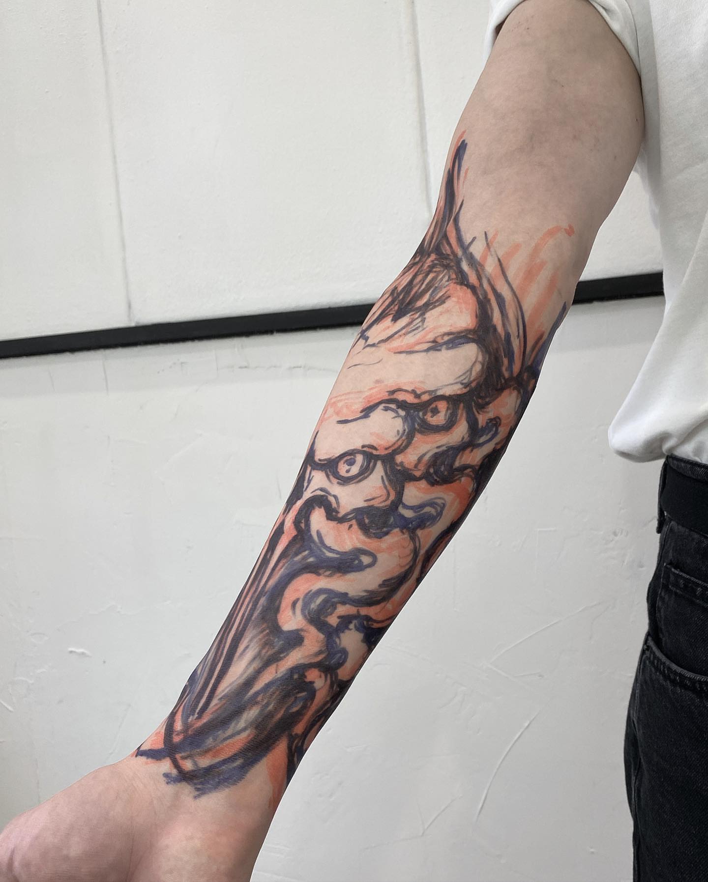 Bearded face neo-traditional tattoo on the forearm by Dark Gothic Tattoo