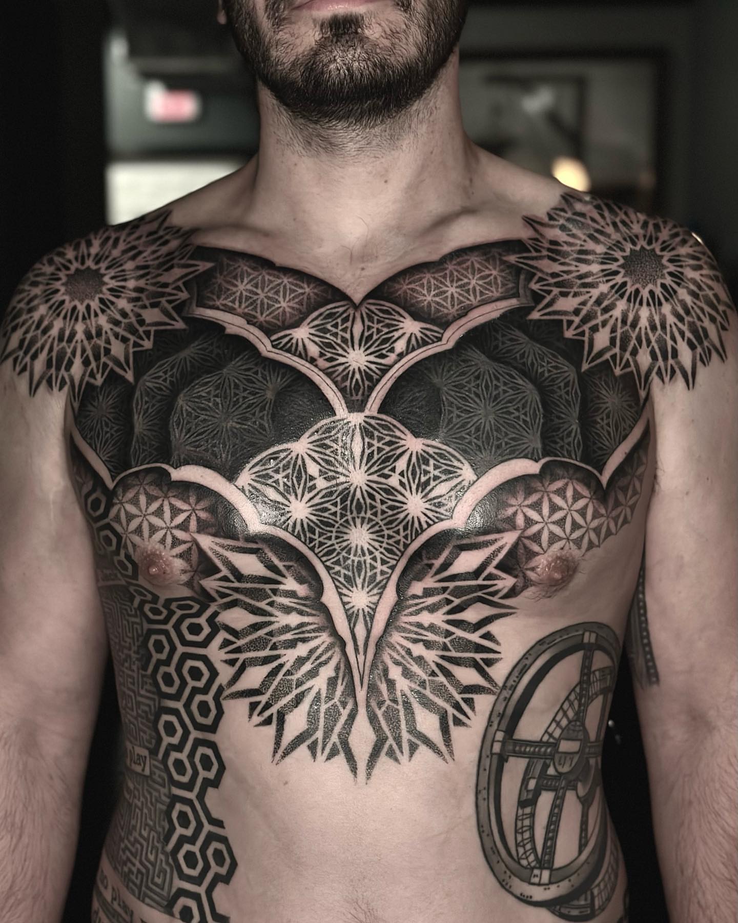 Geometric mandala geometric tattoo on the chest by Nick Fierro
