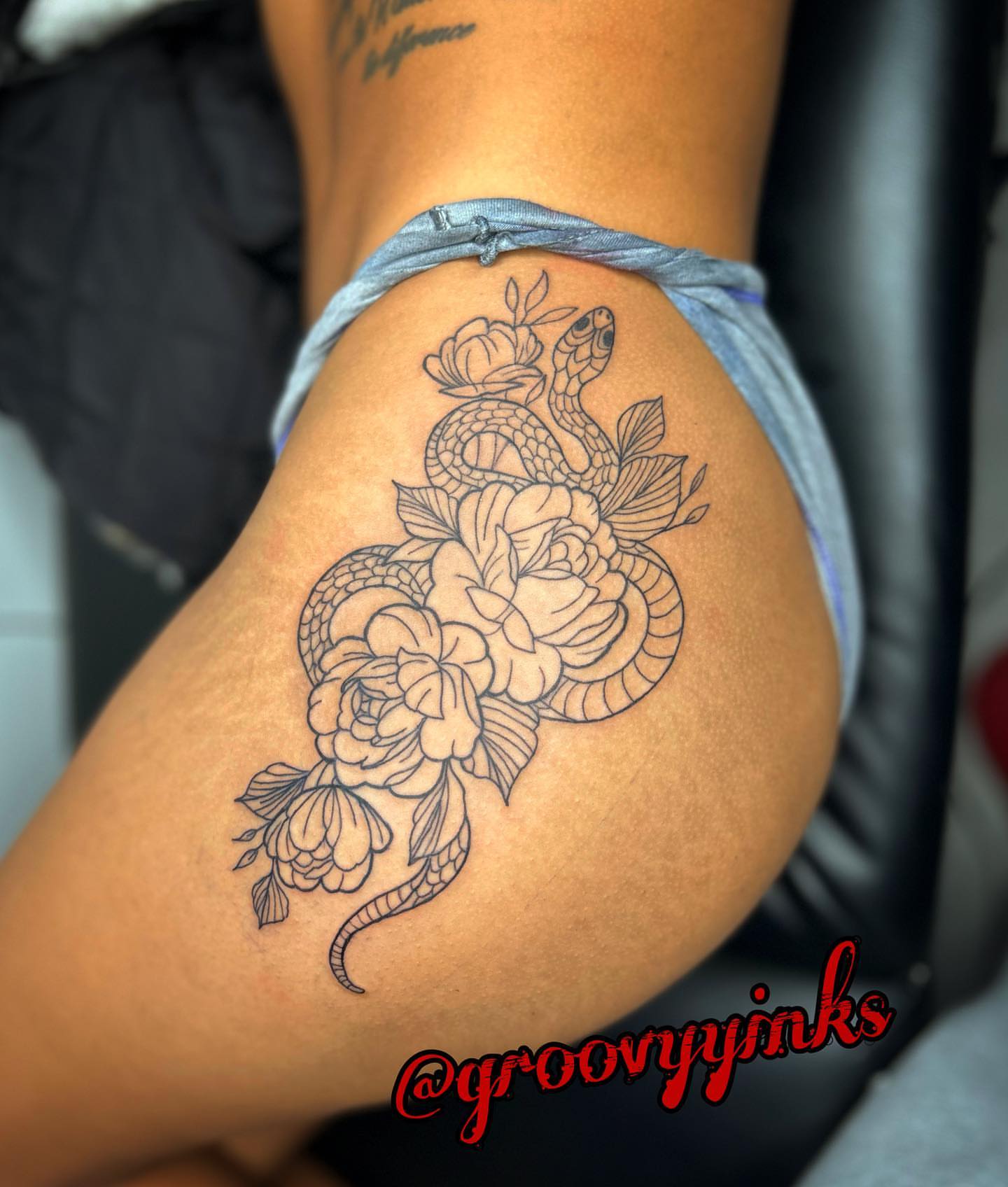 Snake and peony black and grey tattoo on the thigh by groovyyinkss