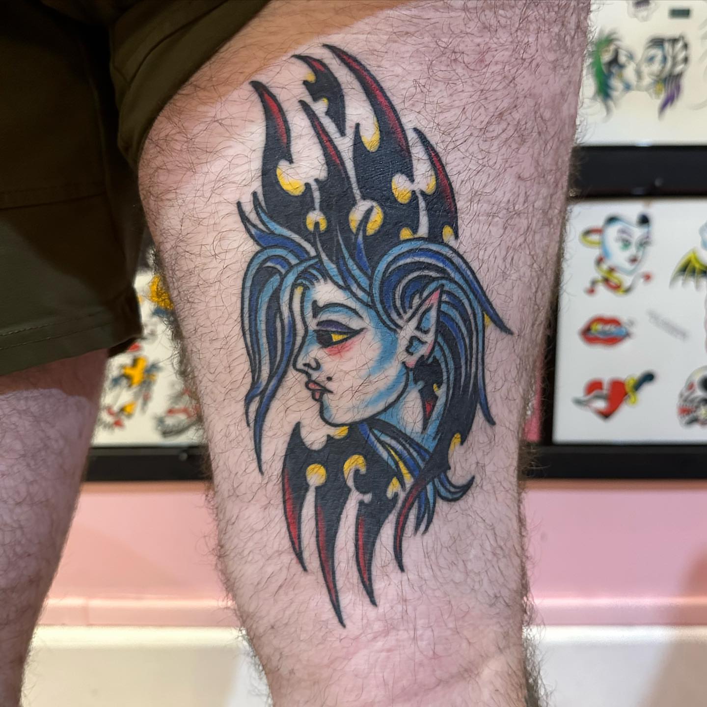 Woman with elaborate headdress American traditional tattoo on the thigh by Isaac Brethauer