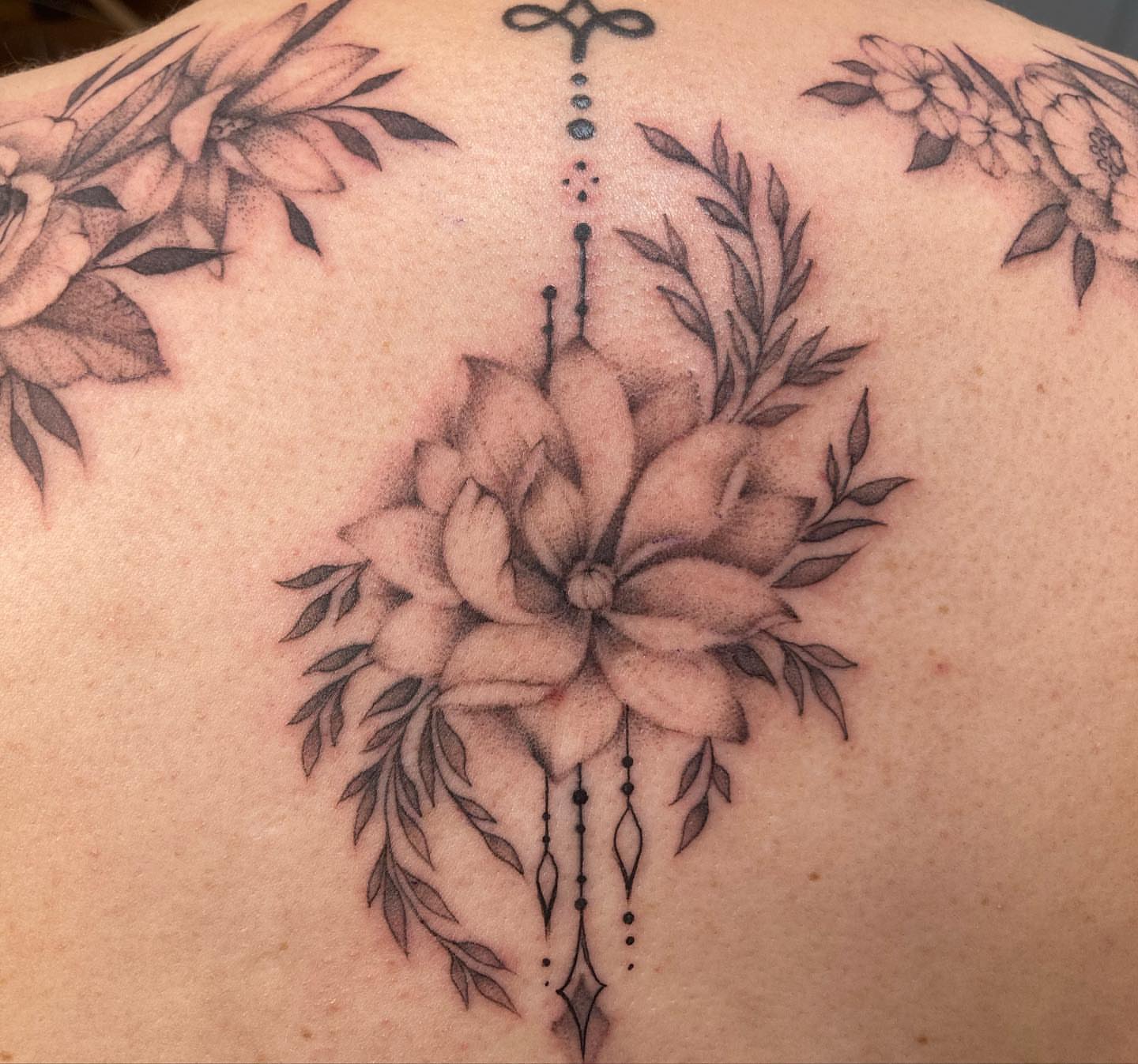 Lotus flower dotwork tattoo on the back by Hali Larkin