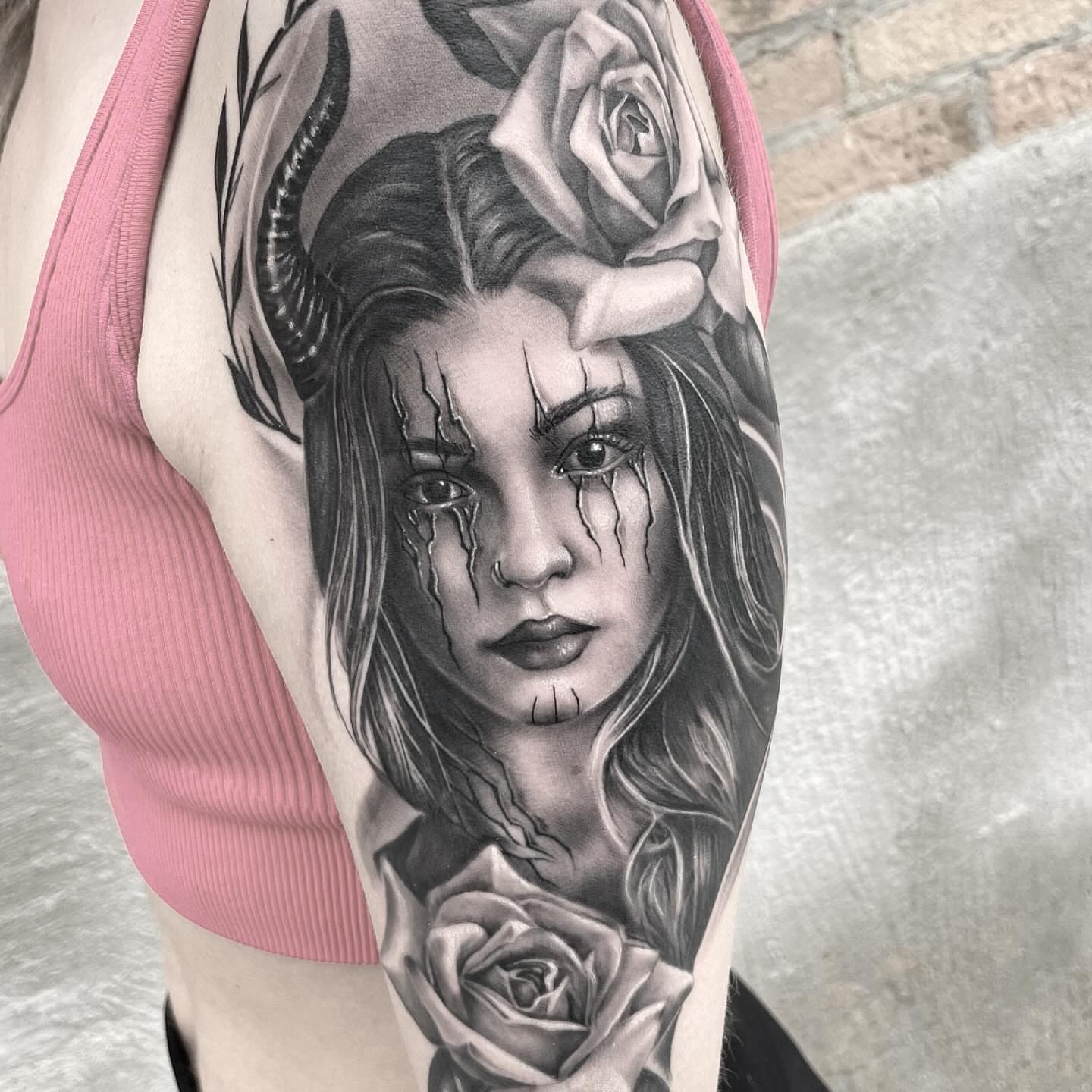 Female portrait with roses realism tattoo on the forearm by mike hudson