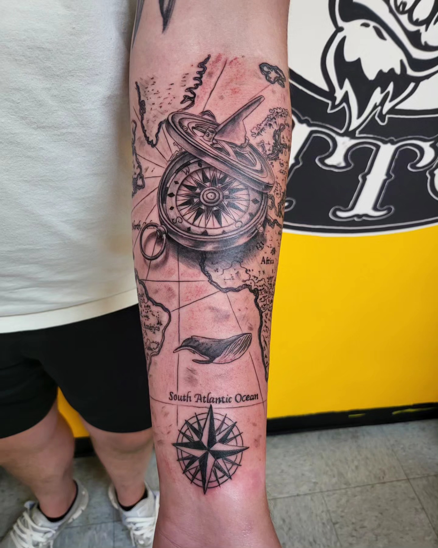 Compass and map realism tattoo on the forearm by Mike Stamper