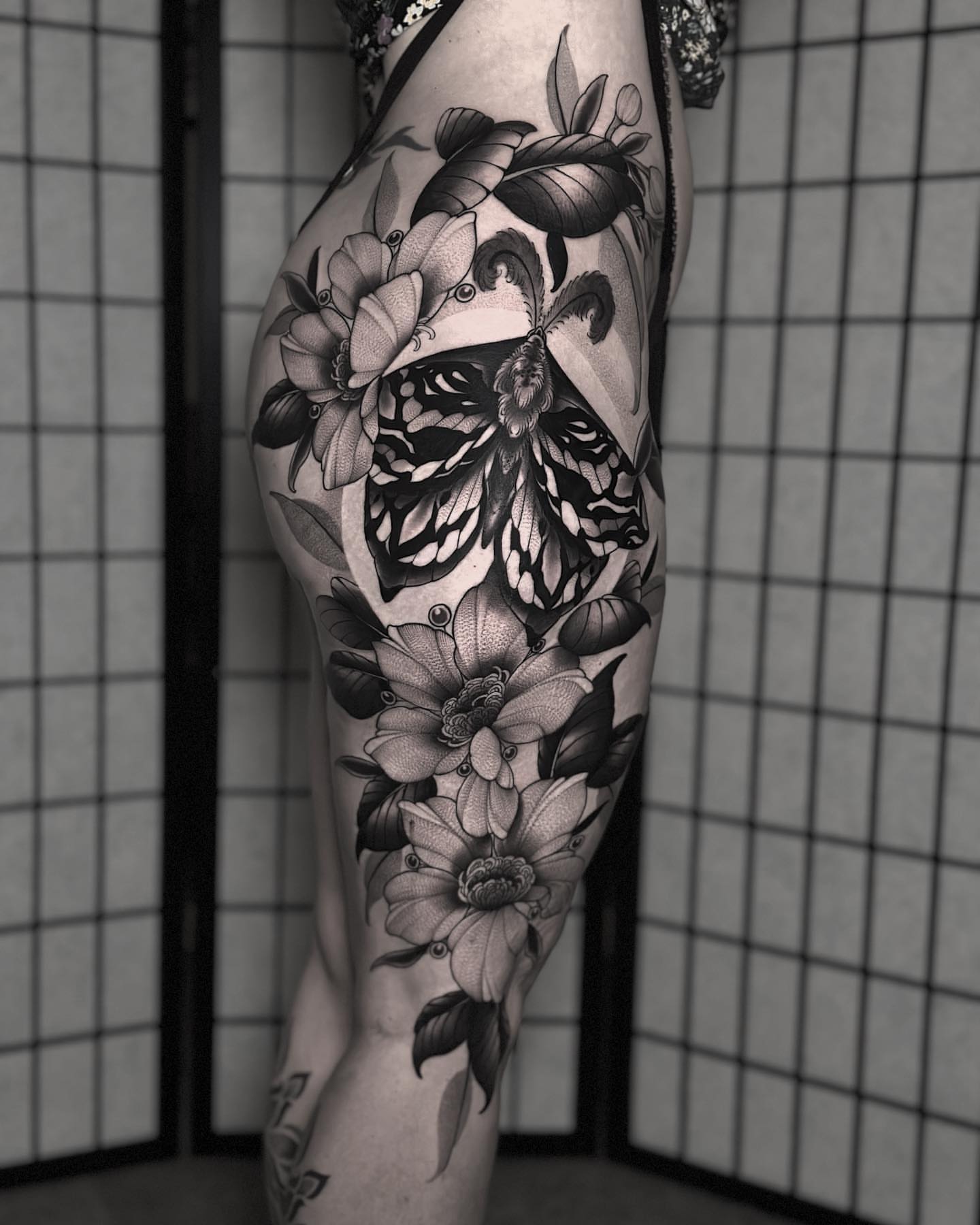 Butterfly and flowers realism tattoo on the forearm by San Diego