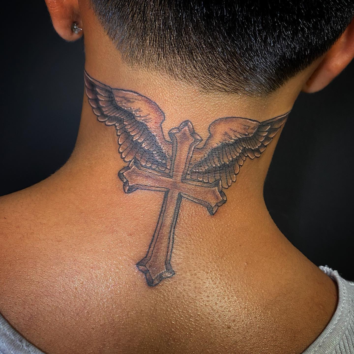 Cross with wings black and grey tattoo on the neck by Anthony Pichardo 🦇