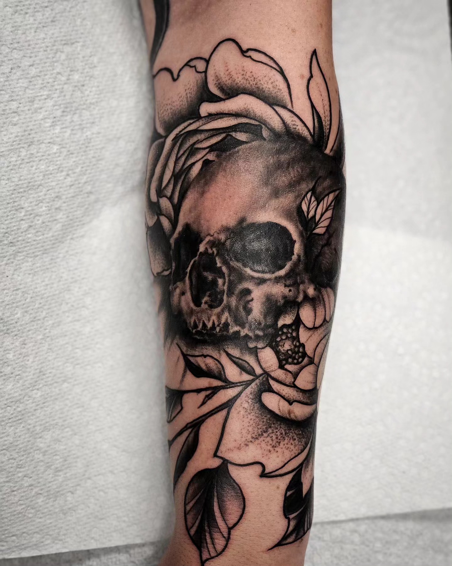 Skull and rose realism tattoo on the forearm by Chicagoland Tattoo artist - Dany Rojas