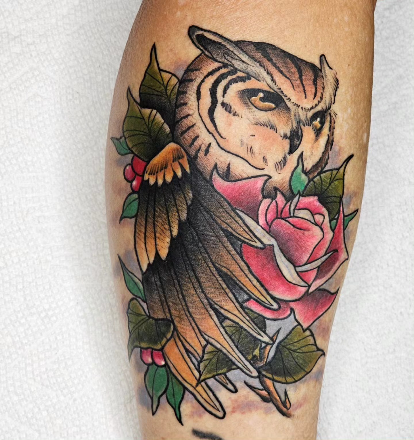 Owl and rose American traditional tattoo on the forearm by BZ Artistry