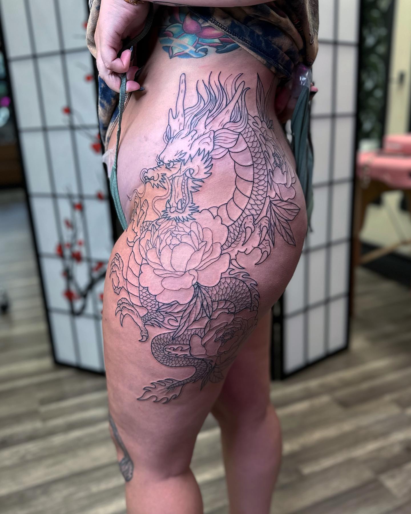 Dragon and peony japanese irezumi tattoo on the thigh by Diana Kunz