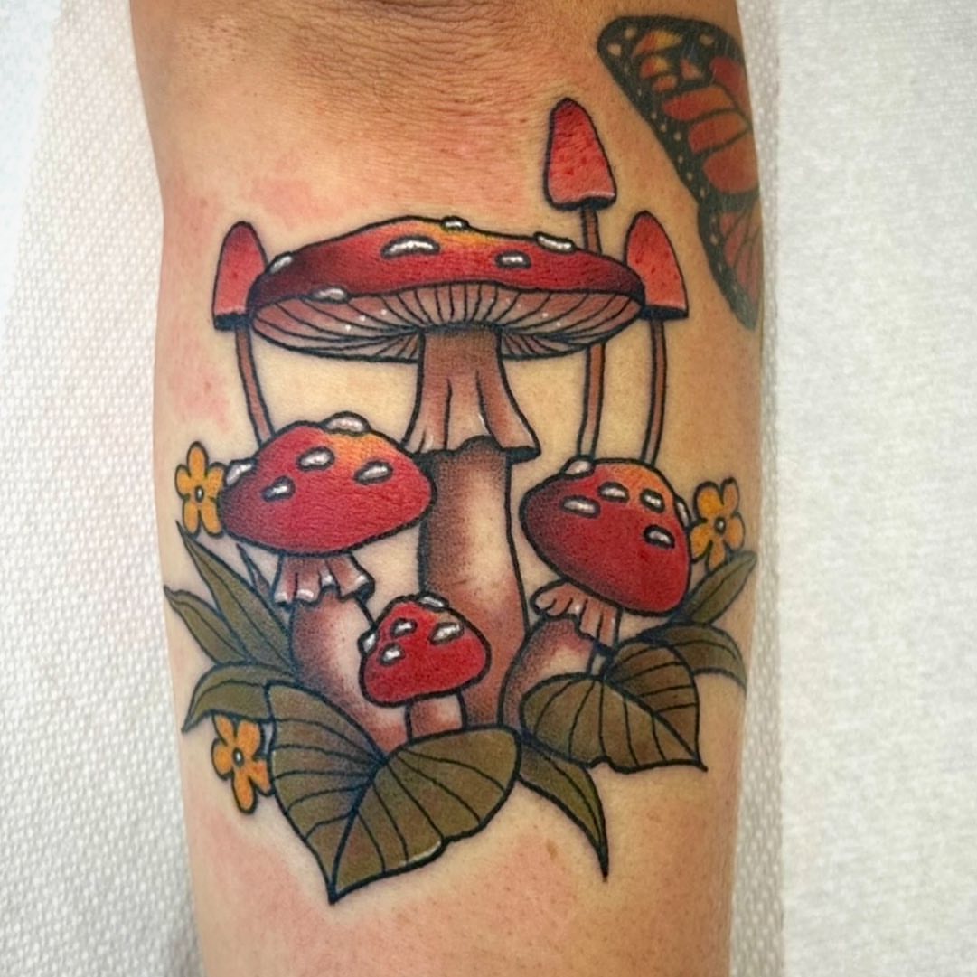 Mushrooms and flowers American traditional tattoo on the forearm by Danielle Dubois